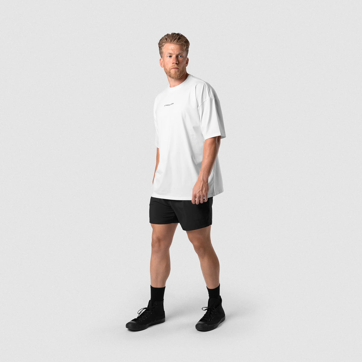 Male model wearing the Axis 6" Lined Shorts - Black/Black full-body front view