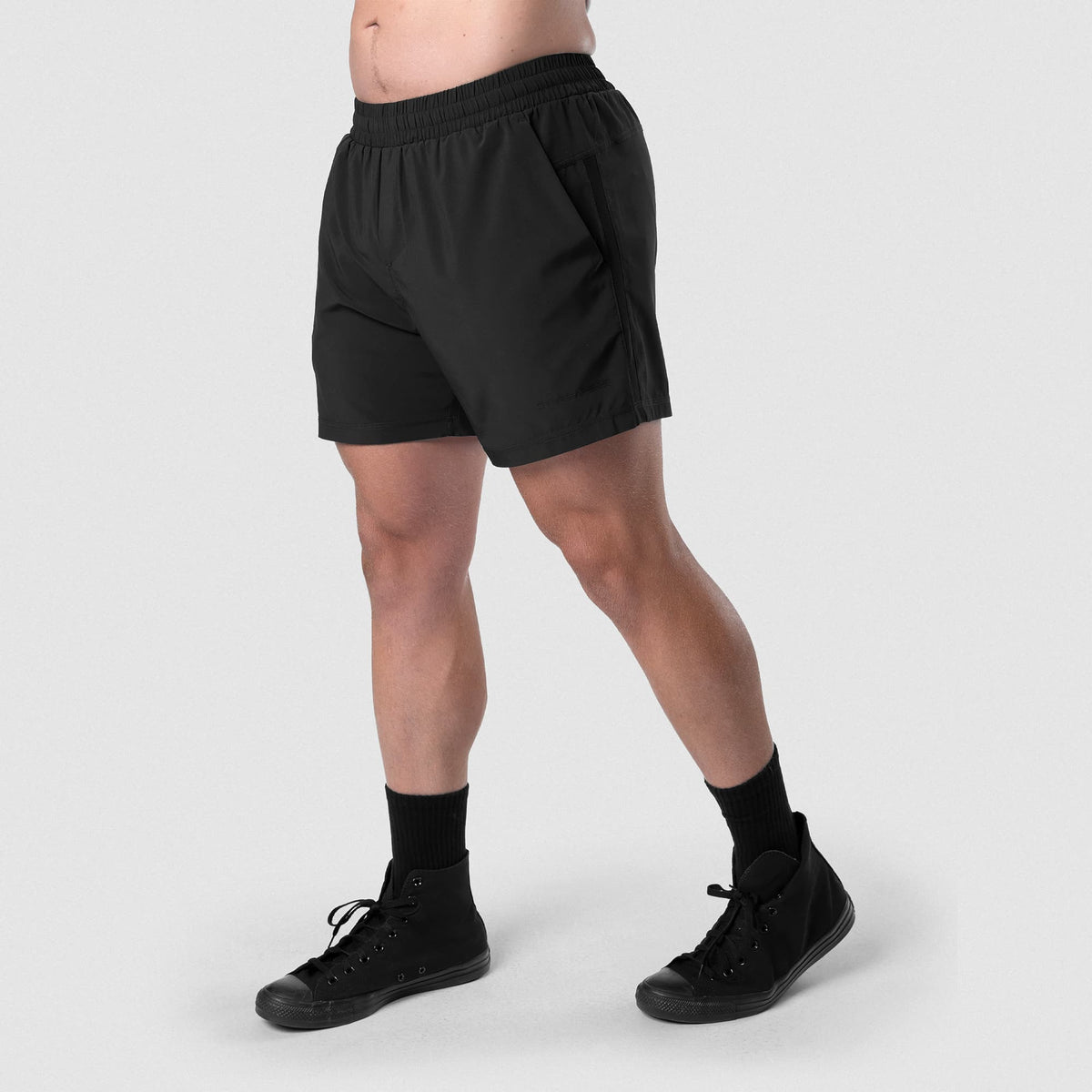 Male model wearing the Axis 6" Lined Shorts - Black/Black side view
