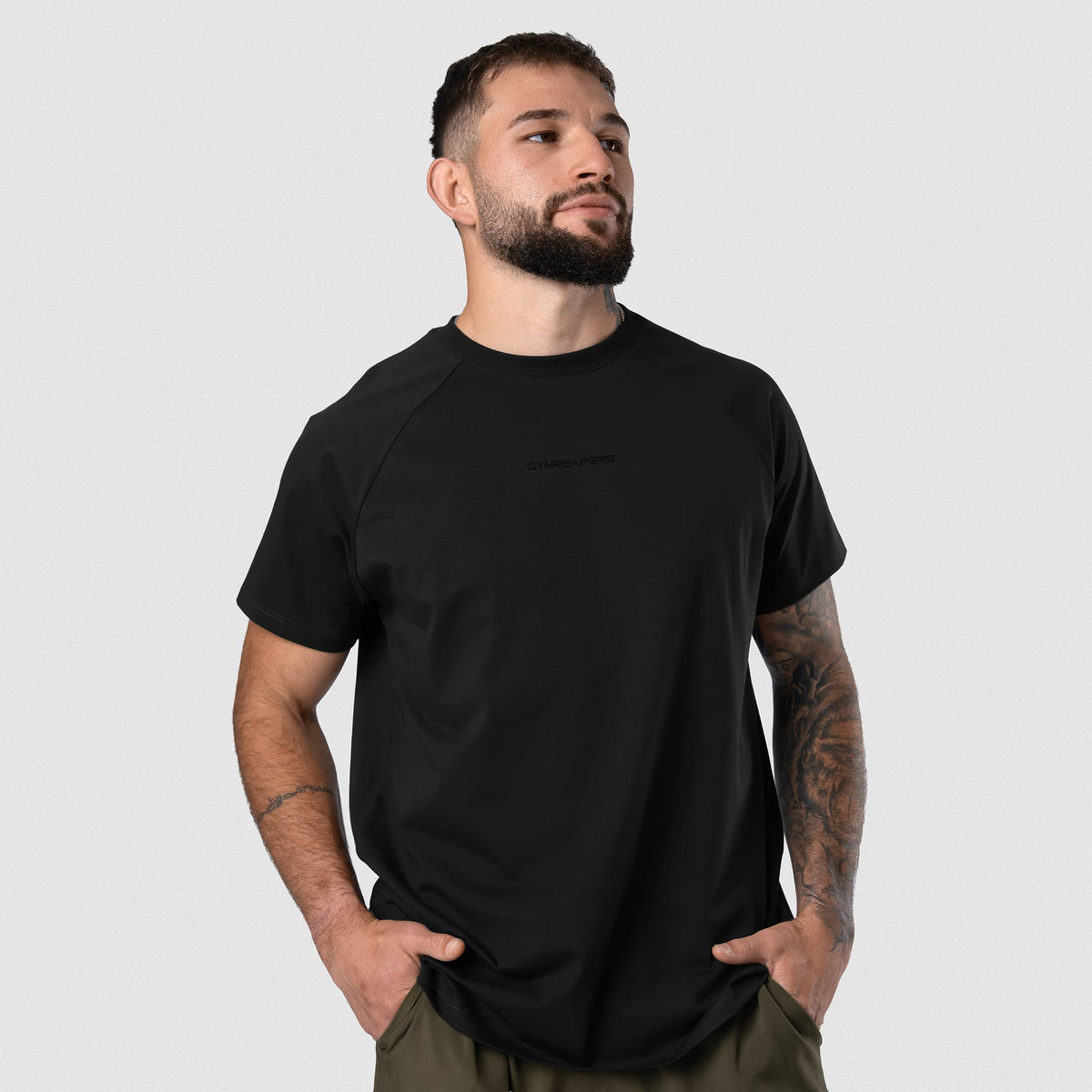 Male model wearing the Axis Raglan Tee - Black/Black front view