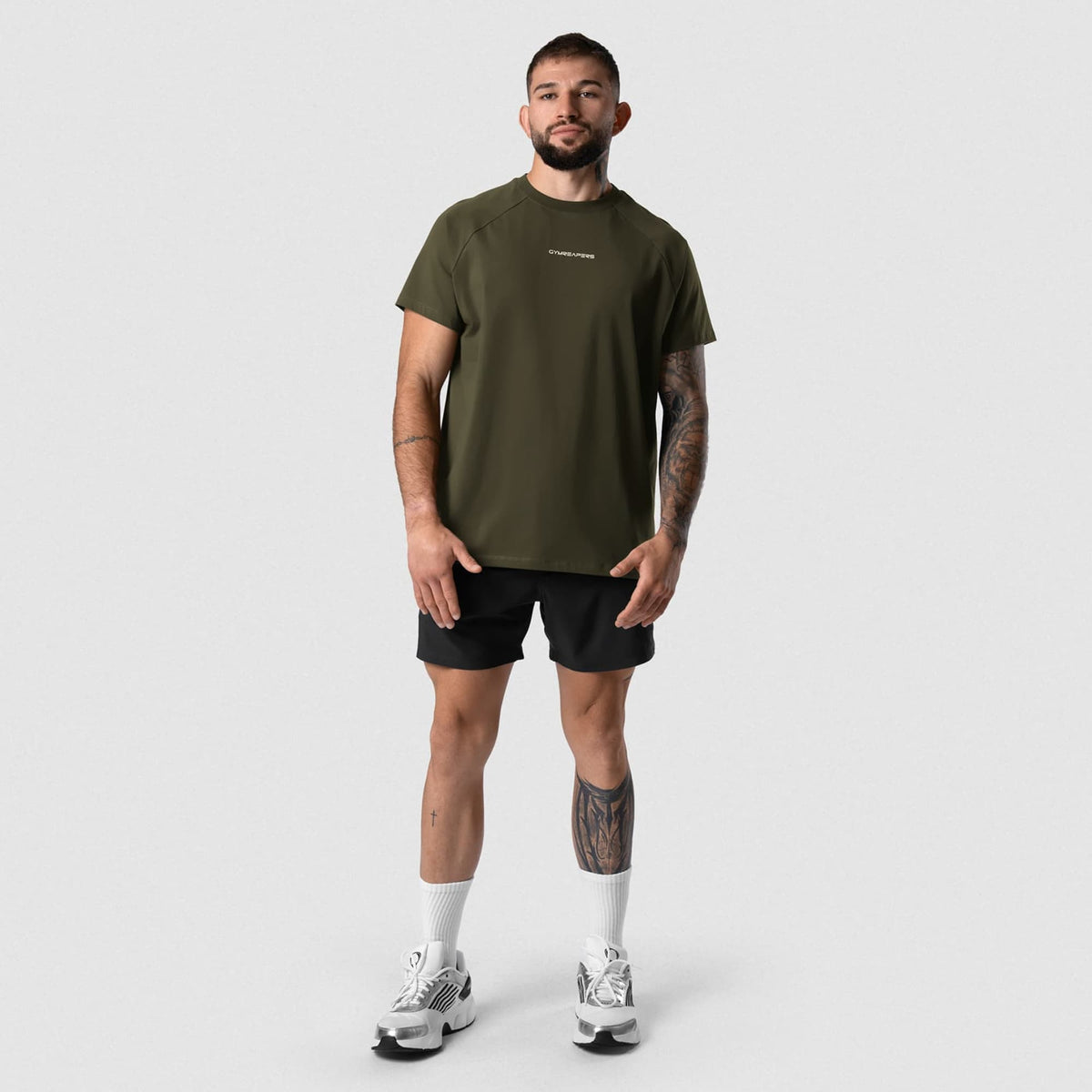 Male model wearing the Axis Raglan Tee - OD Green full-body view