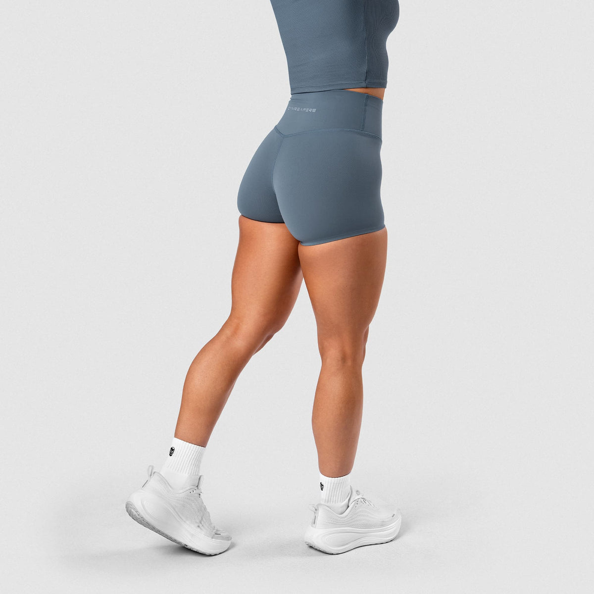 Female model wearing the Axis 4" Shorts - Lake side view