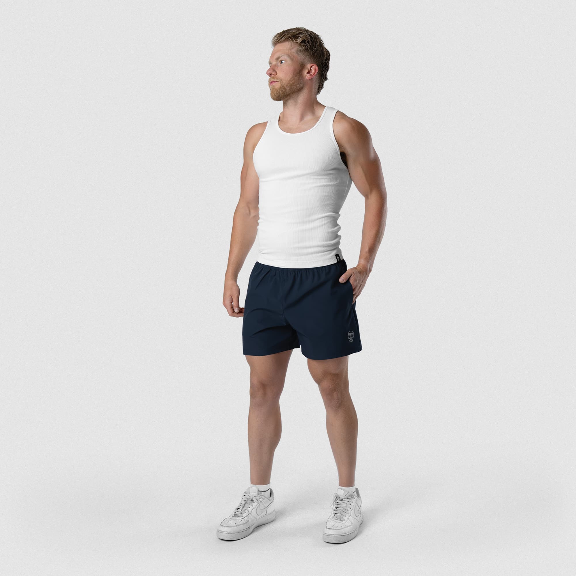 Model wearing Men's Conquer 5 Inch Shorts - Navy