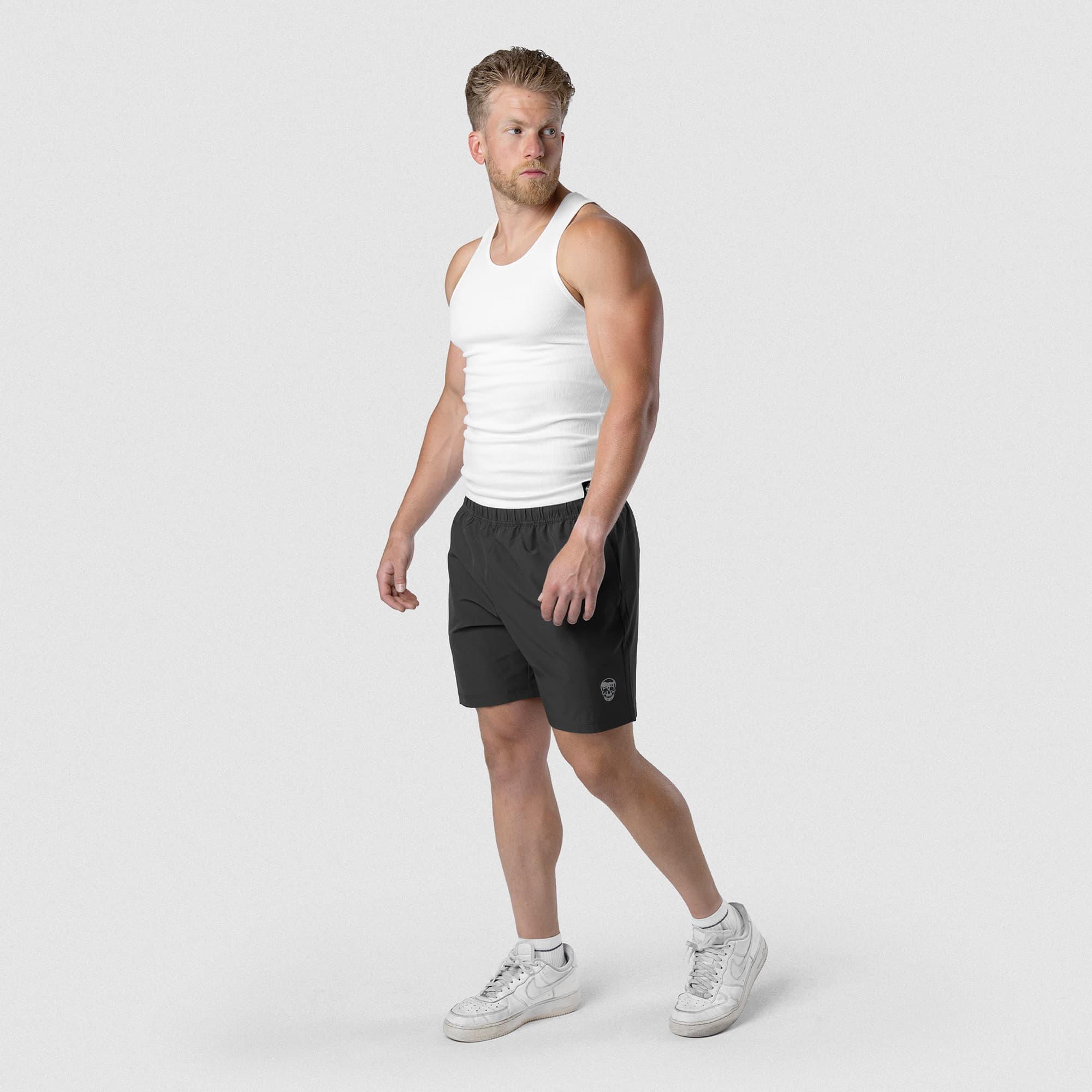 Model wearing Men's Conquer 7 Inch Shorts - Dark Gray