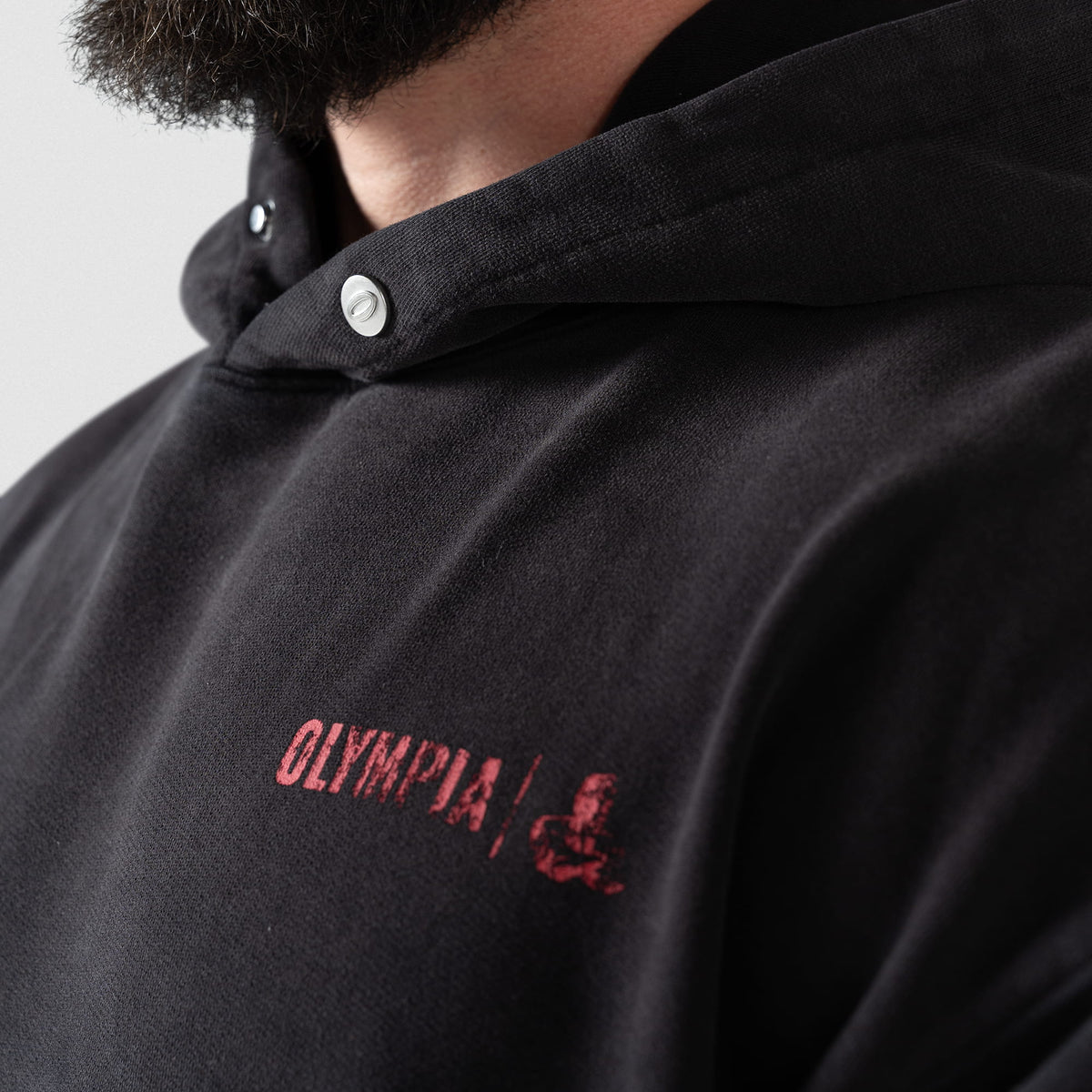 Championship Hoodie | Close up of small red "Olympia" logo on the chest