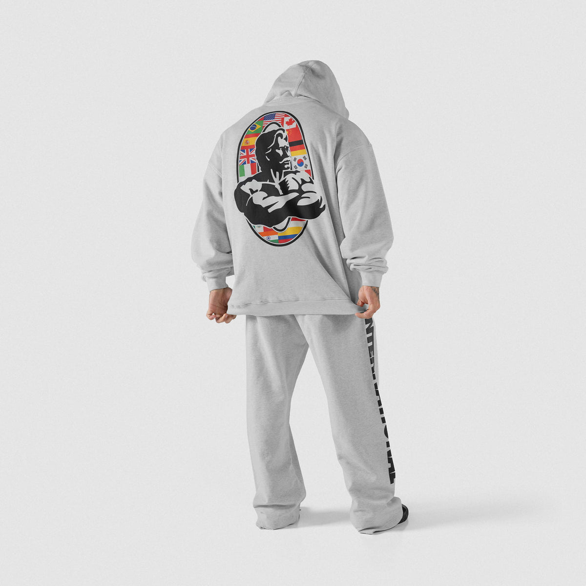 International Division Hoodie | Male model wearing the gray pullover with matching joggers facing away