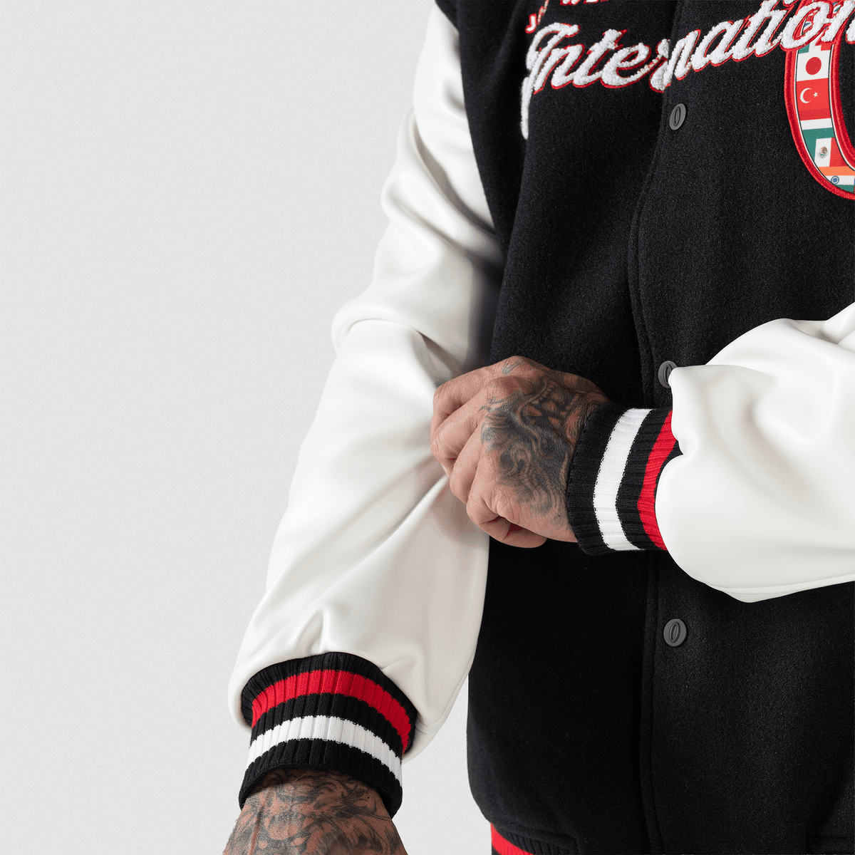 Olympia International Division Varsity Jacket in Black – On Model, Sleeve and Cuff Detail