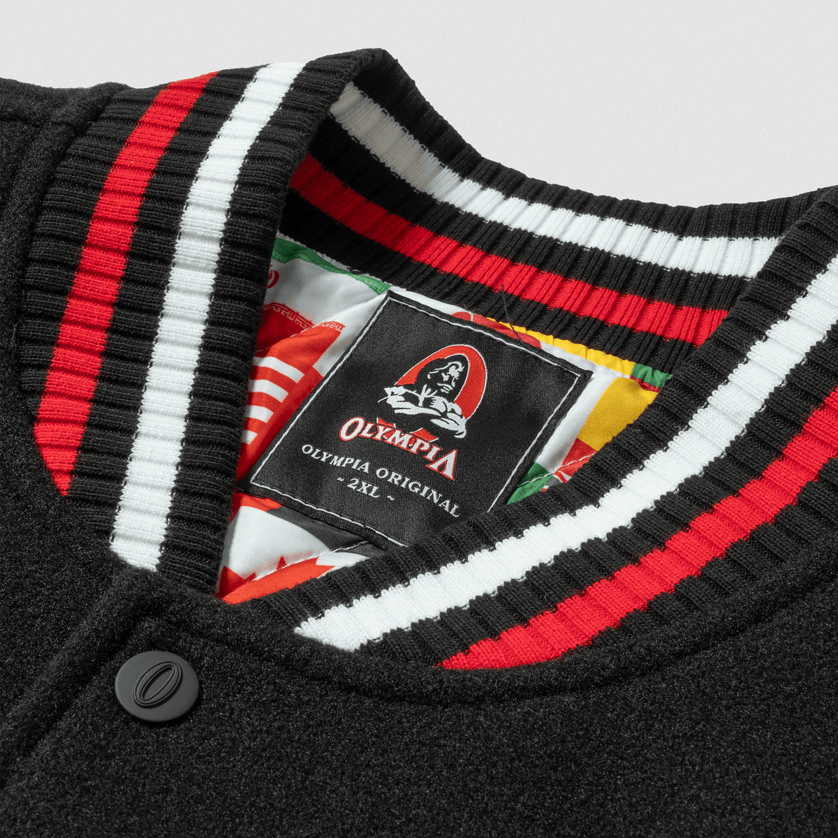 Olympia International Division Varsity Jacket in Black – Collar Patch and Snap Button Detail