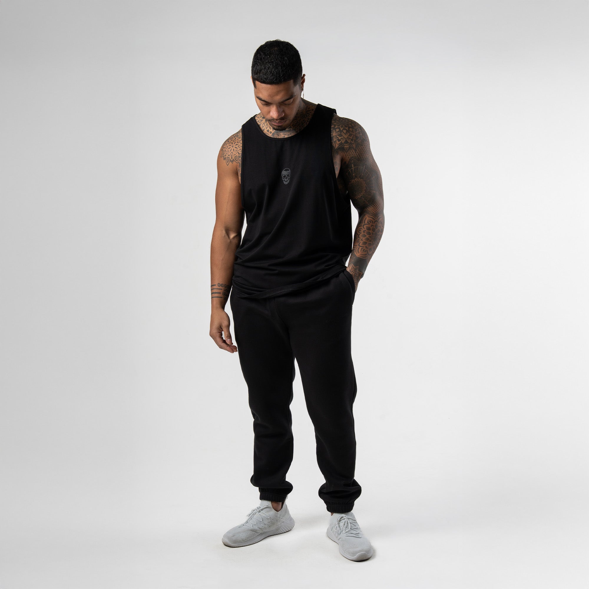 Athlete wearing black axis scoop hem tank full body shot