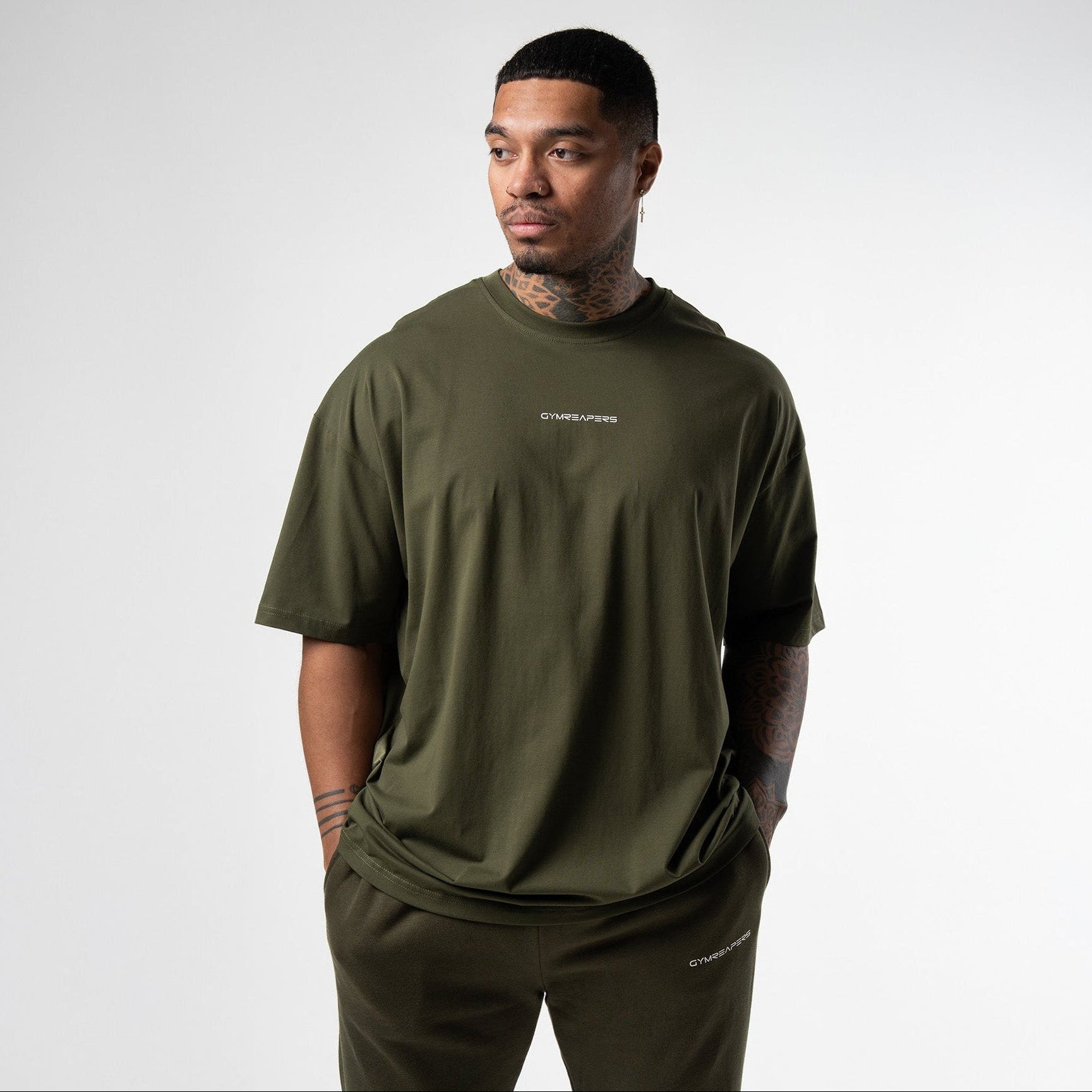 athlete wearing green axis box tee front view