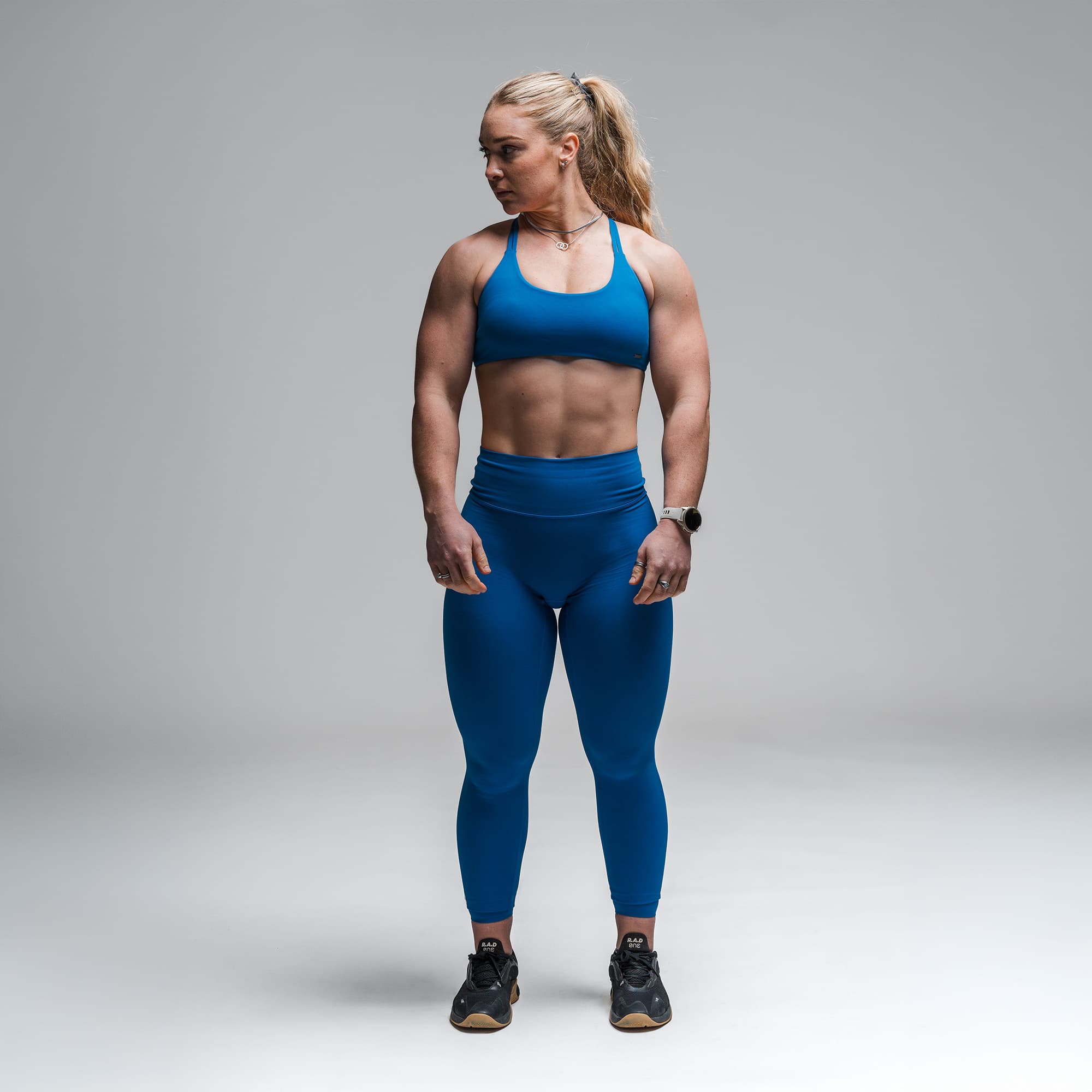 Athlete wearing the Electric Blue Axis Leggings full body shot front view