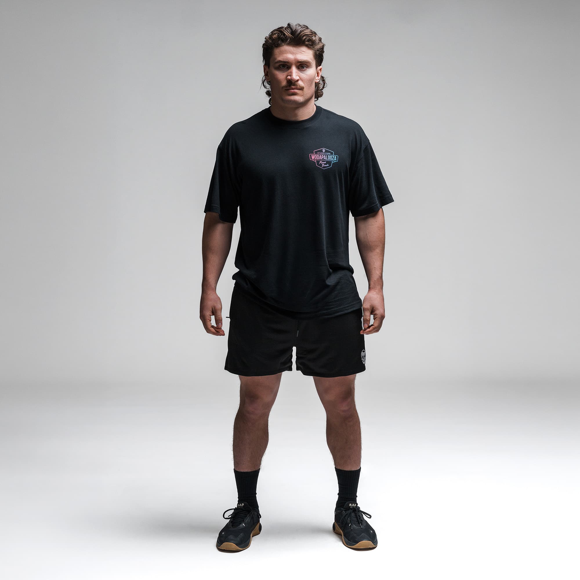 Athlete wearing the Gymreapers WZA Shield Tee full body shot front view
