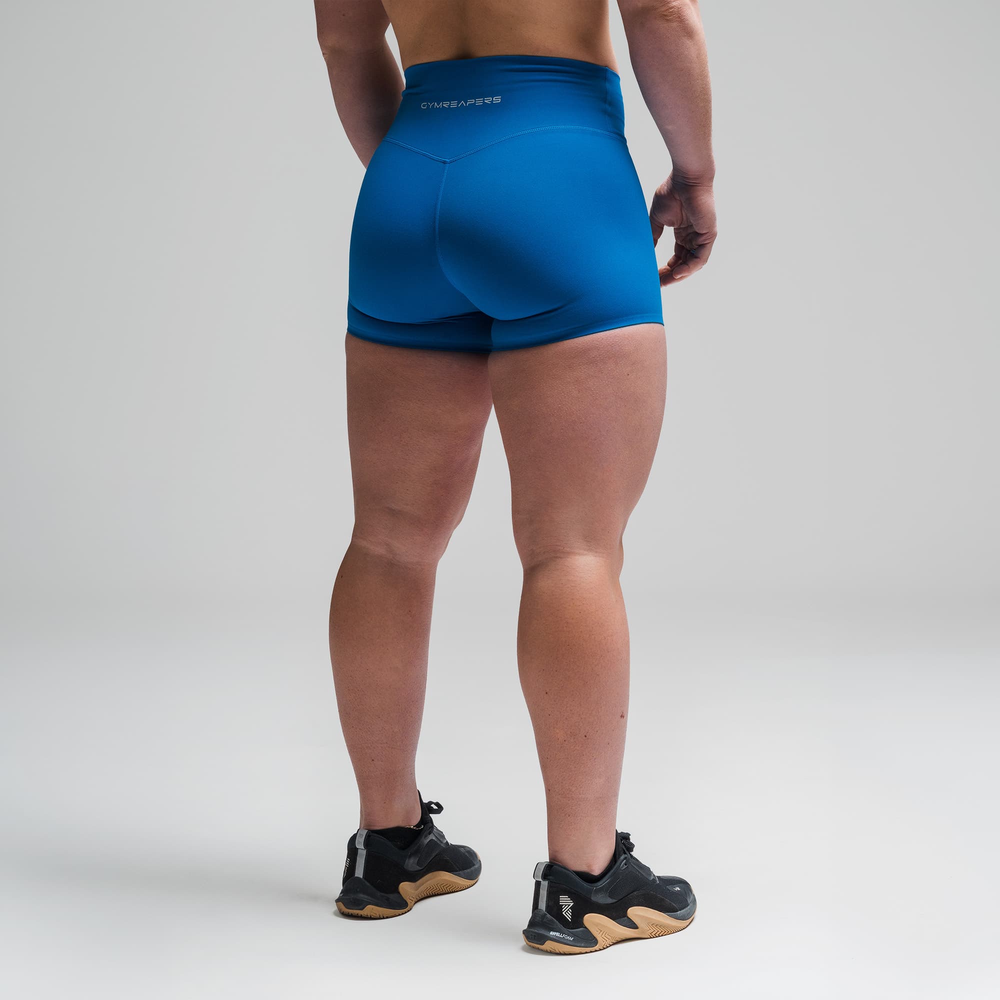 Athlete wearing the Electric Blue Axis 4" Shorts half body shot back view
