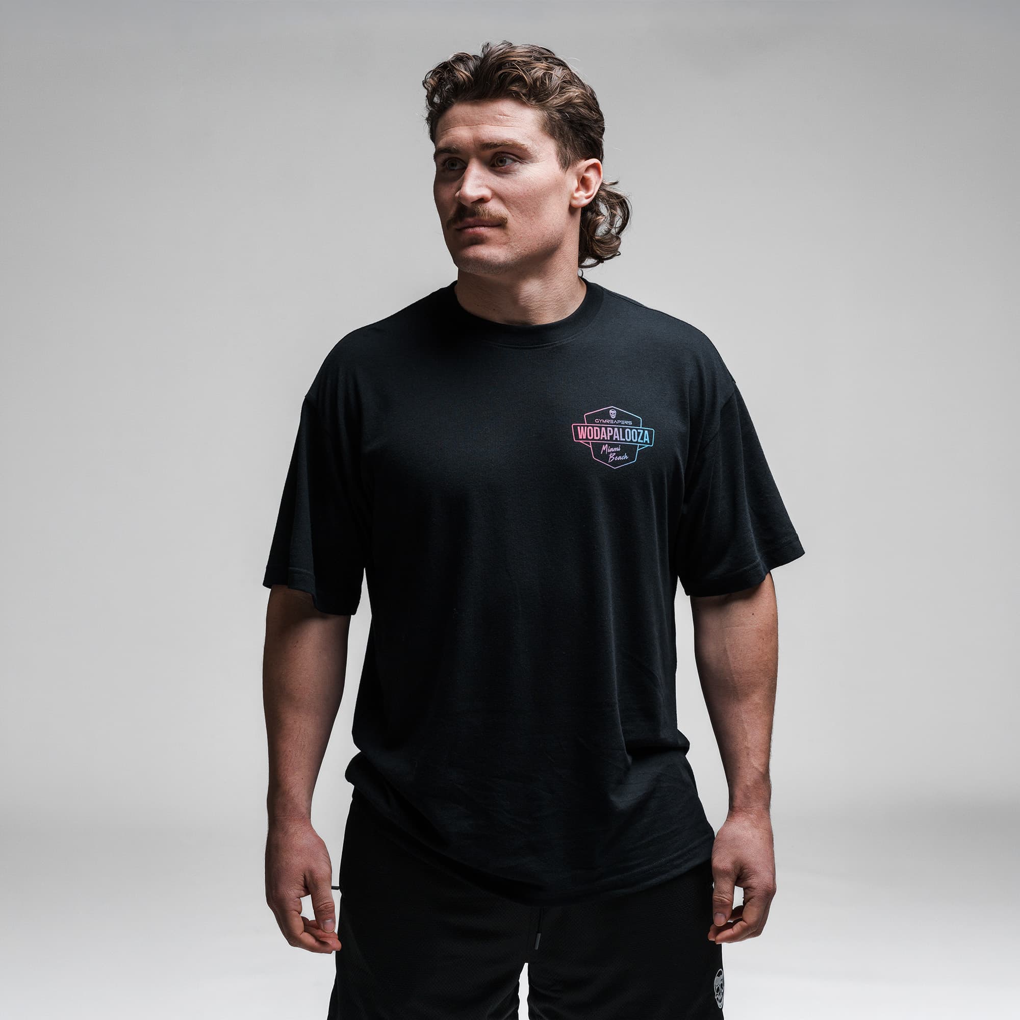 Athlete wearing the Gymreapers WZA Shield Tee half body shot front view