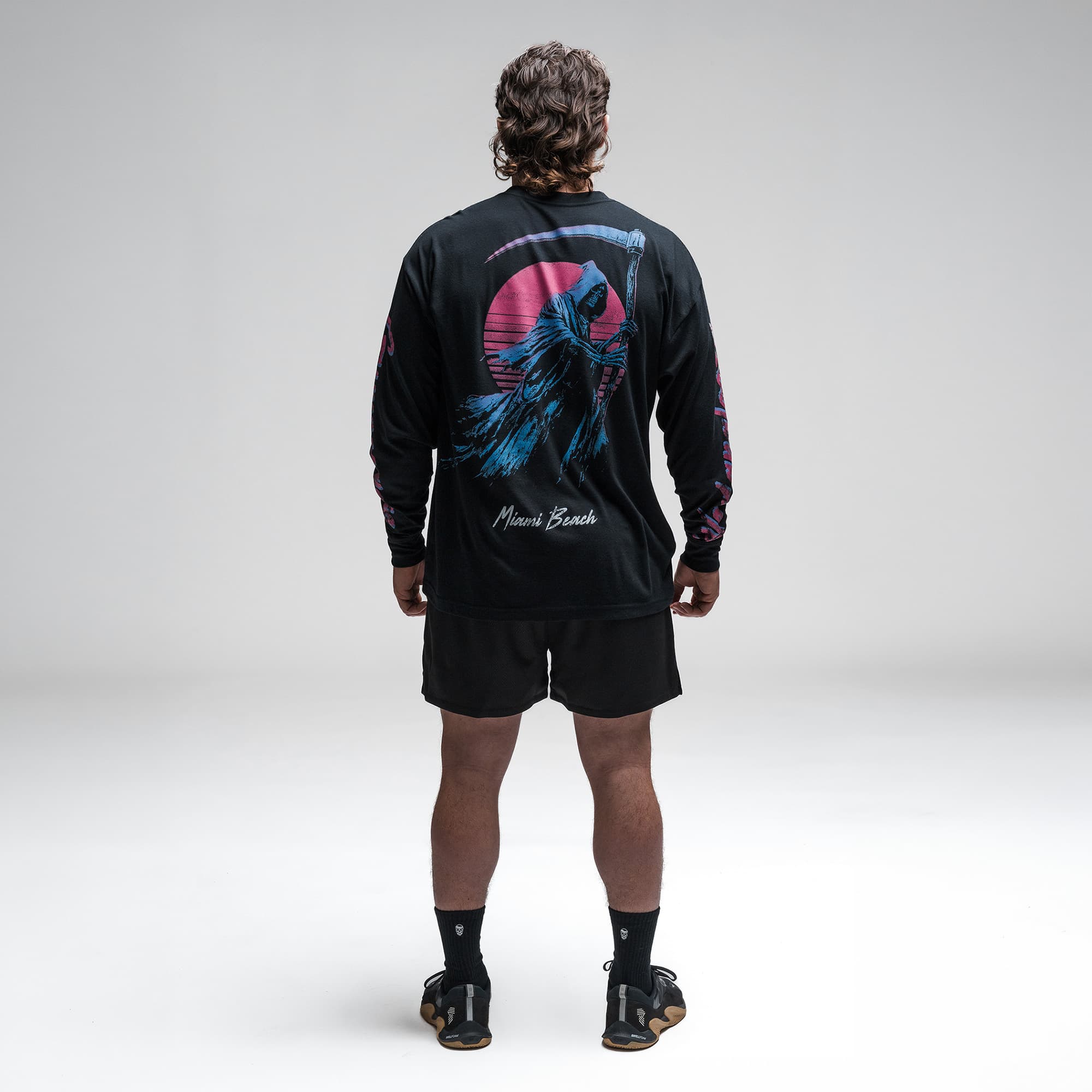 Athlete wearing the Moon Breaker Long Sleeve Shirt full body shot back side