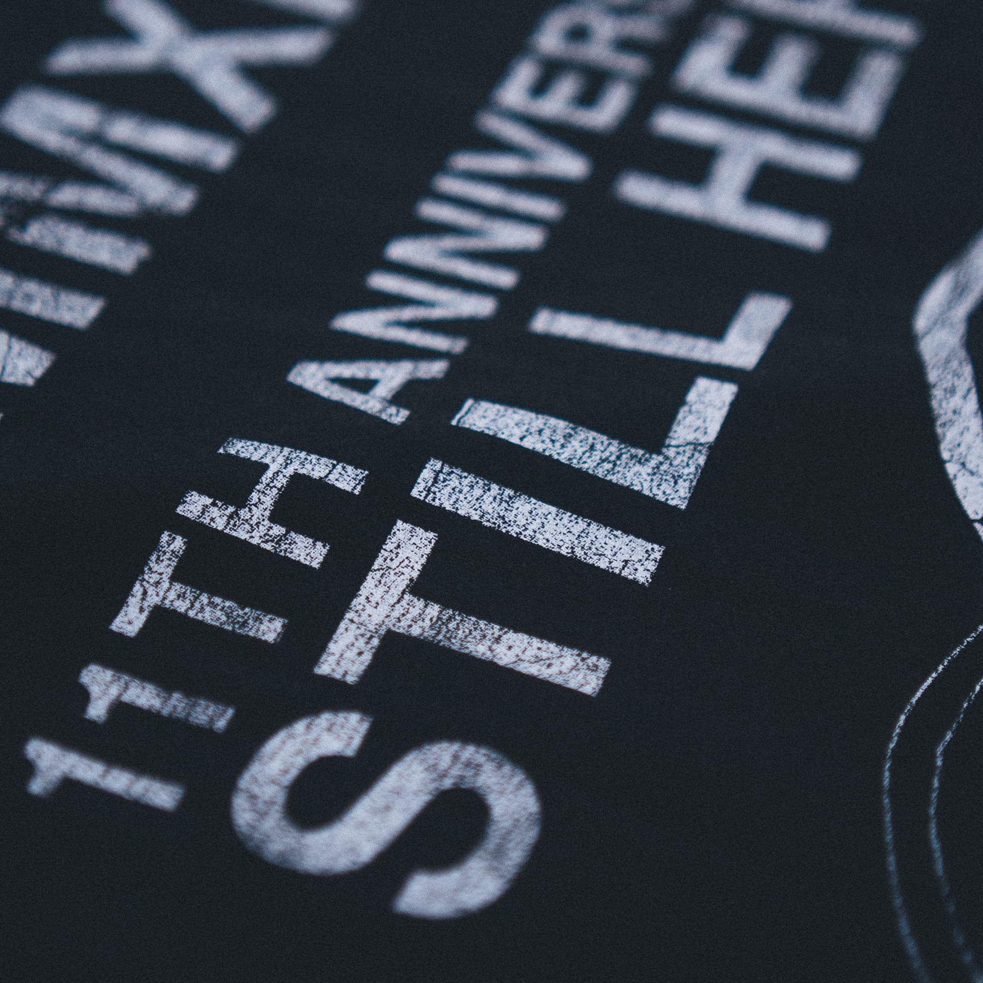 Close up shot of back graphic on 11th anniversary tee.