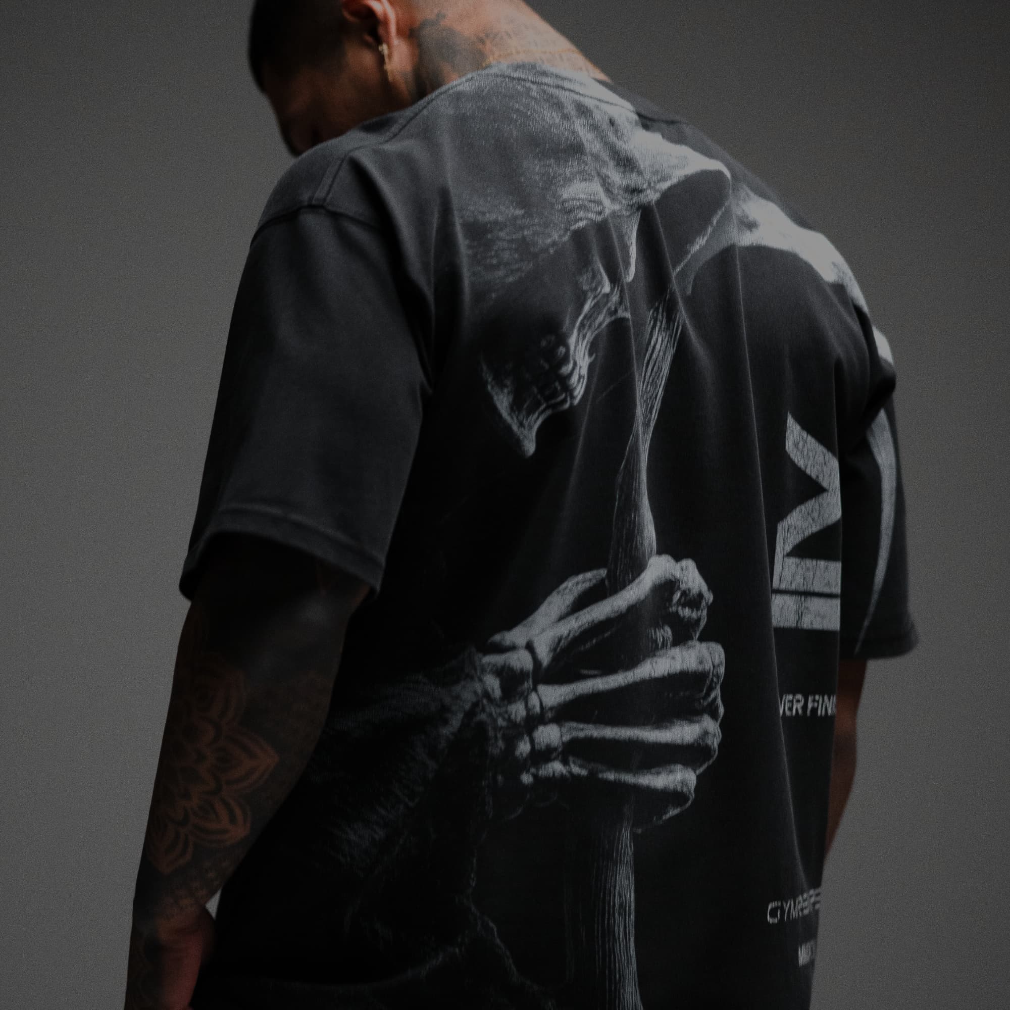 Athlete wearing 12th Anniversary Tee - Never Finished close up shot of back graphic