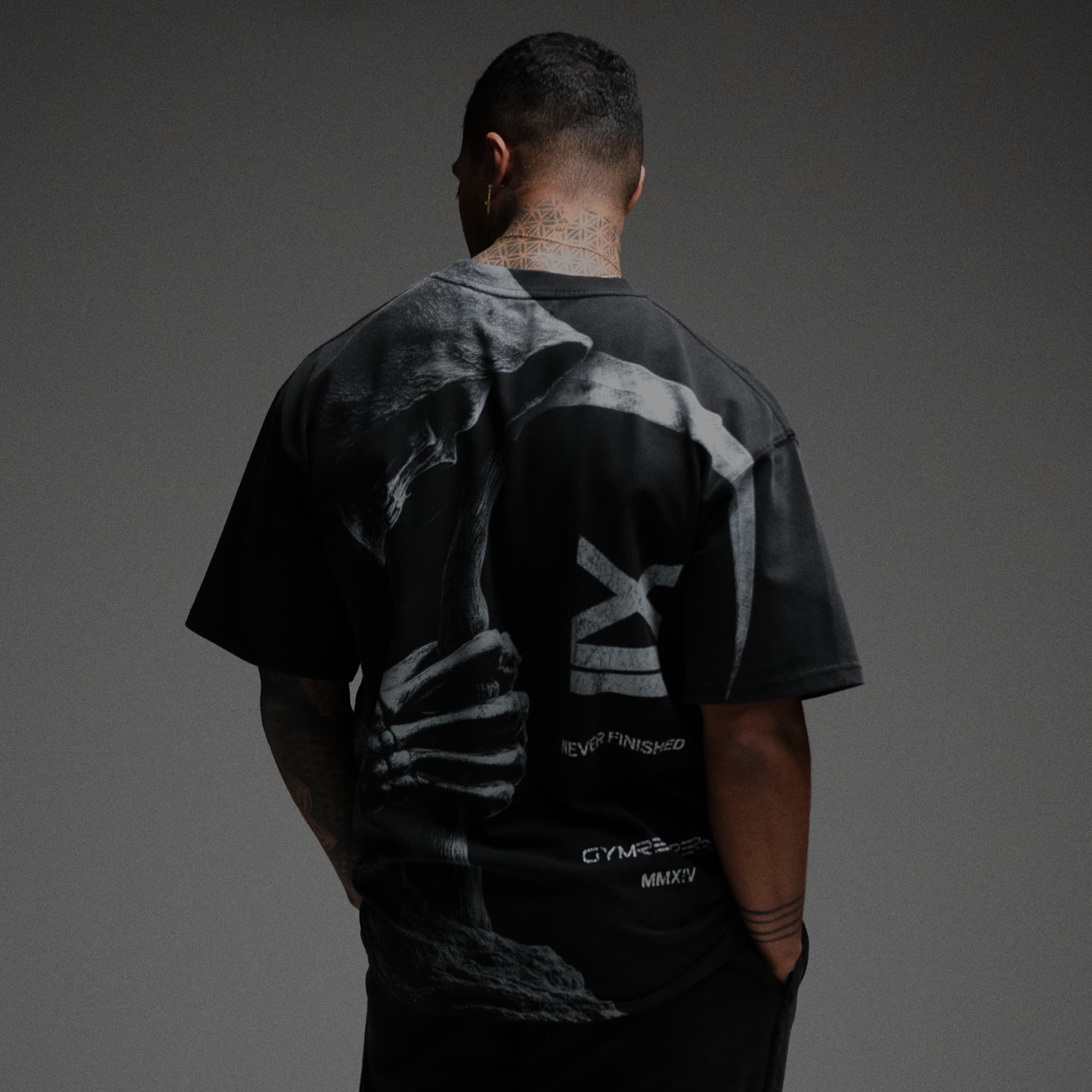 Athlete wearing 12th Anniversary Tee - Never Finished half body shot back view