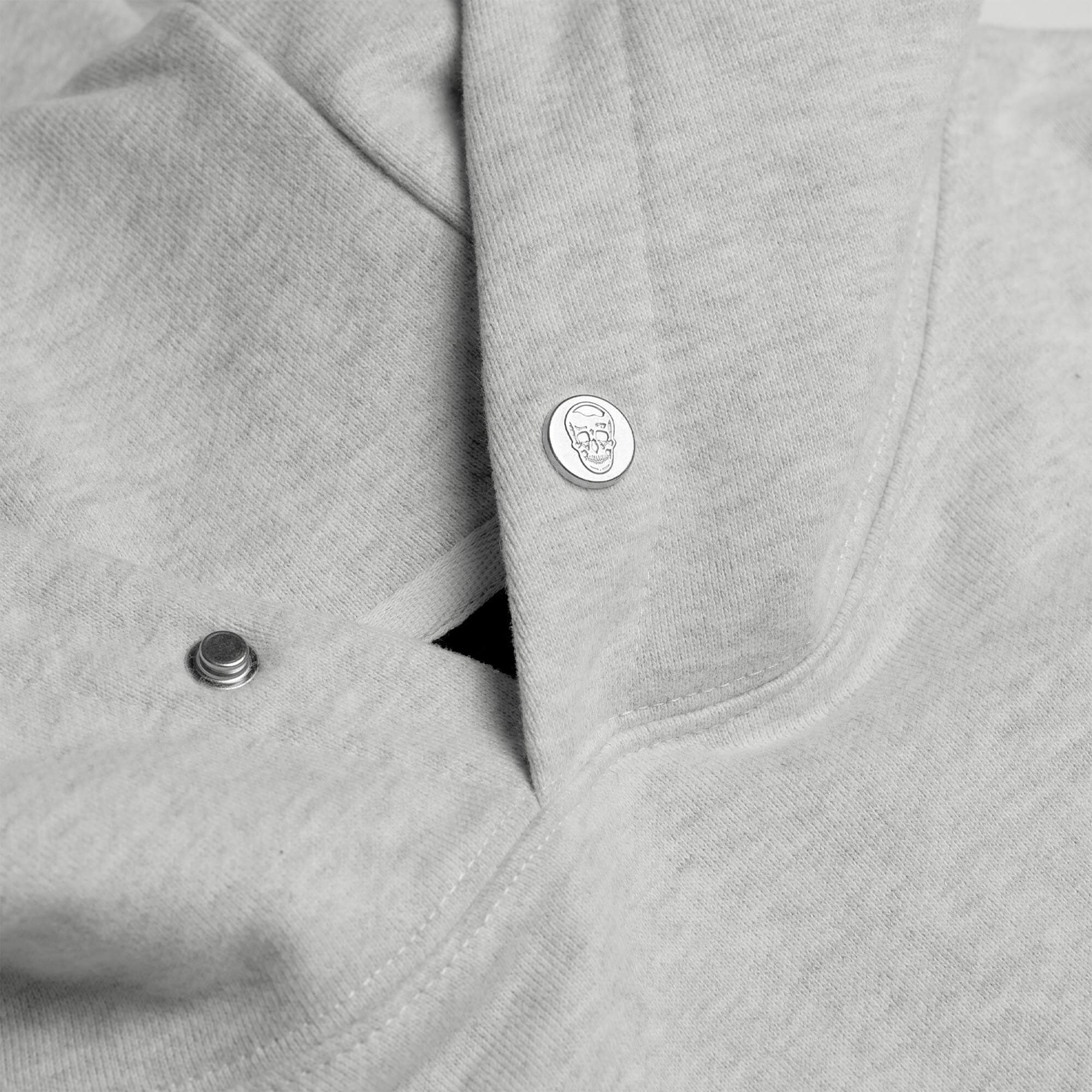 Light Heather Gray Heavyweight Hoodie lay flat detail shot of branded buttons
