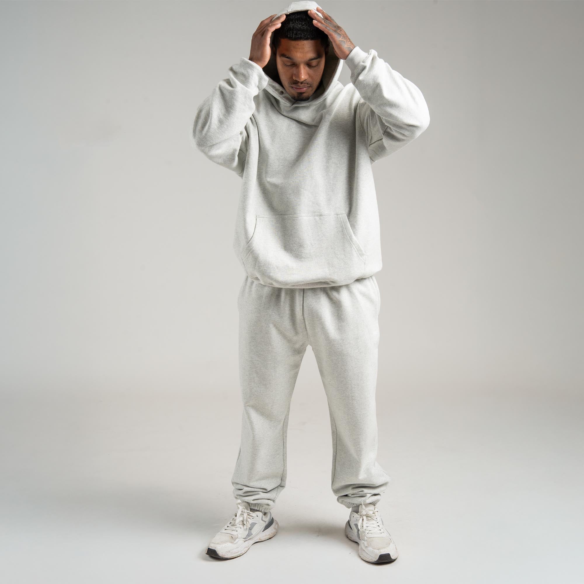 athlete wearing the light heather gray heavyweight set full body shot