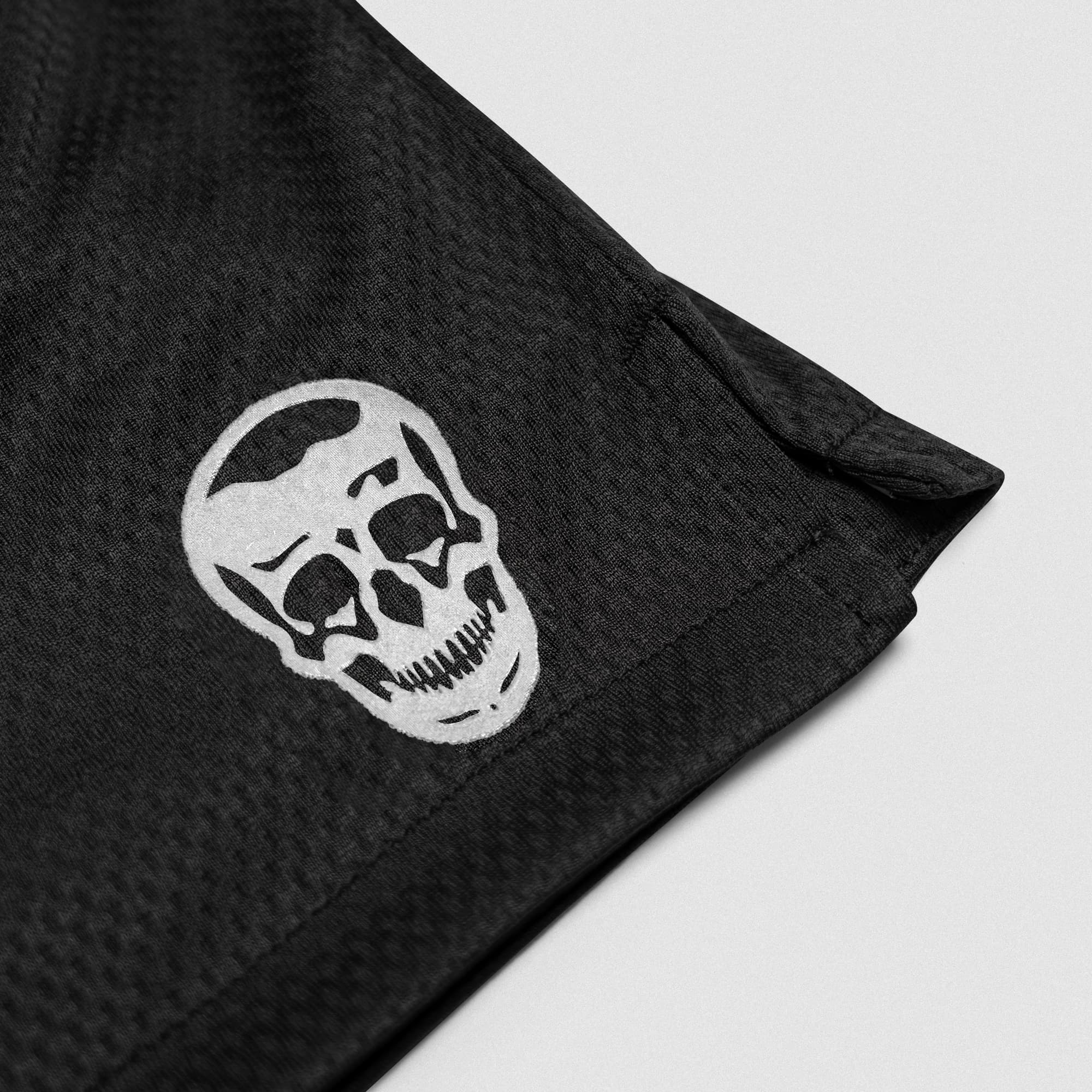 Black/White Core Skull Mesh Training Shorts lay flat detail shot of logo