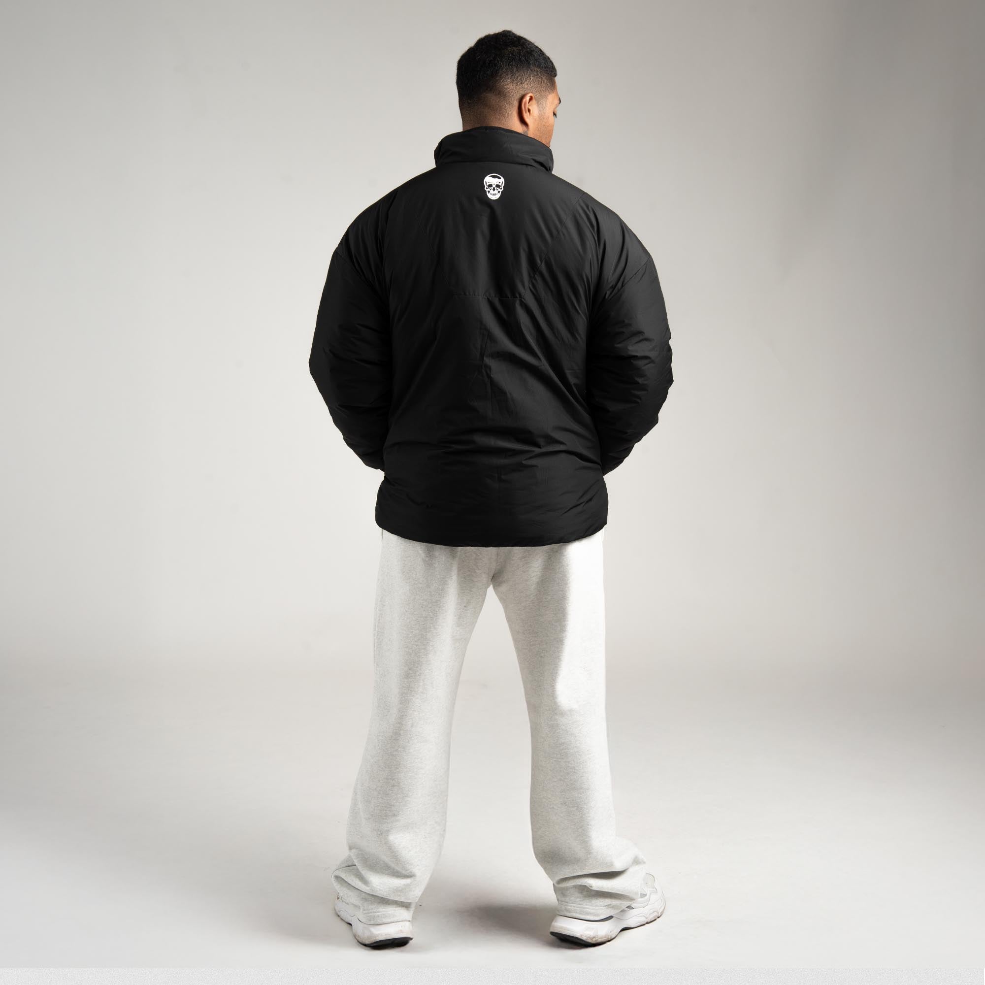 athlete wearing the Arktik Puffer Jacket full body shot back view