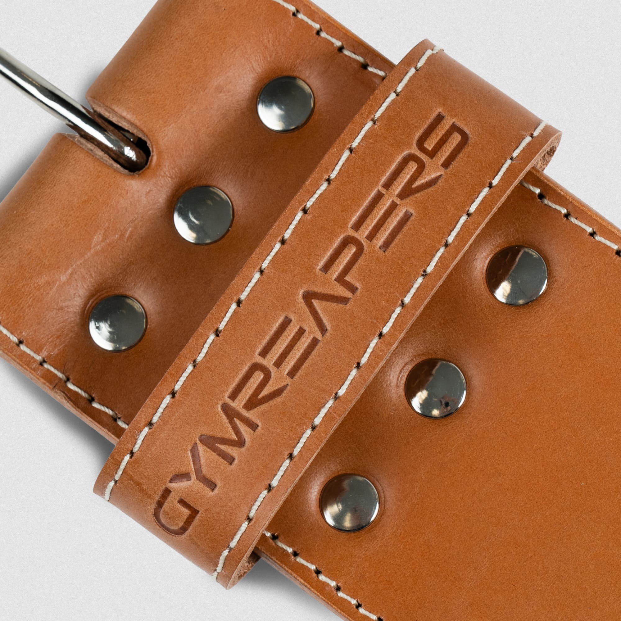 Close up detail shot of the heat-debossed logo on the loop of the heritage single prong belt