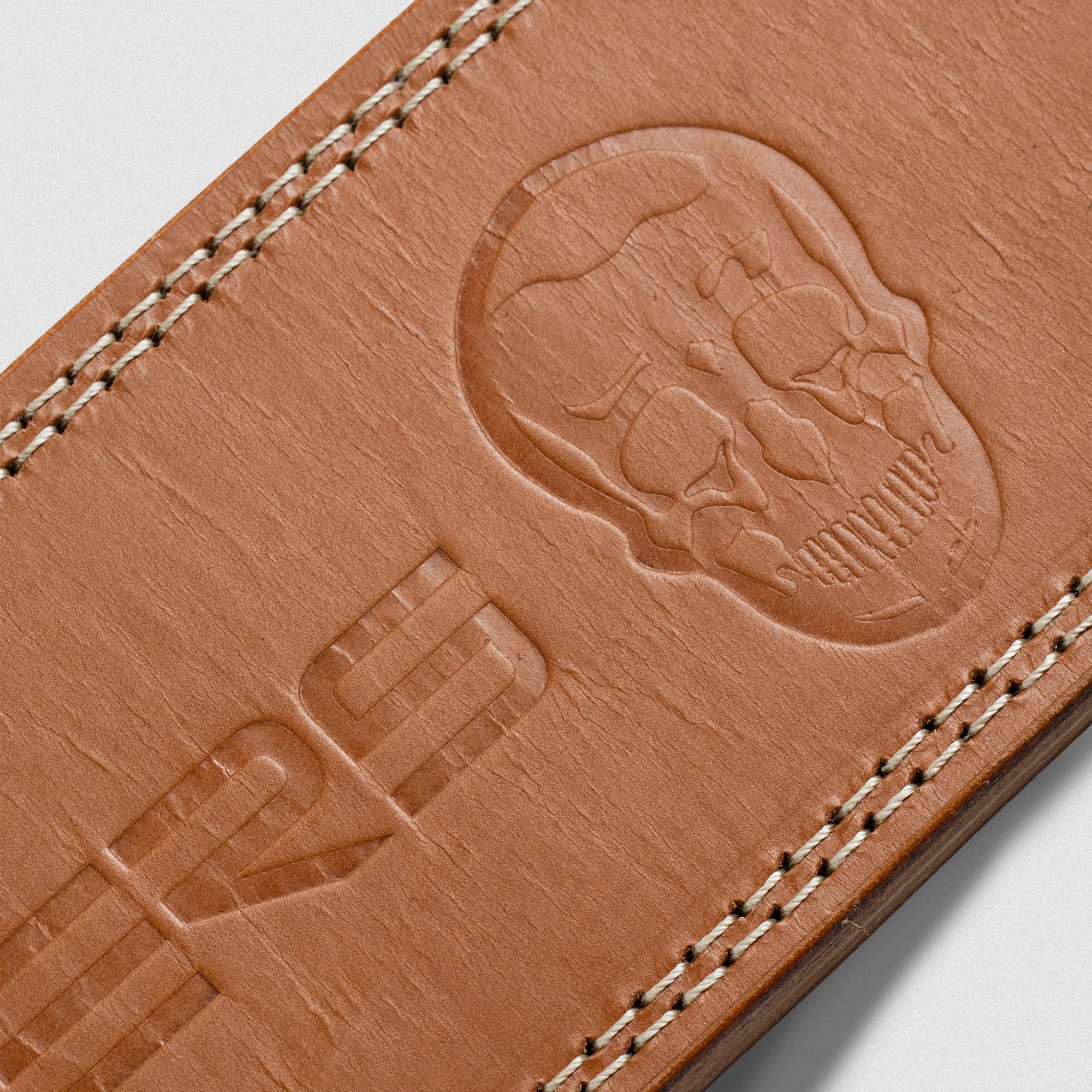Close up detail shot of the heat-debossed logo on the heritage lever belt