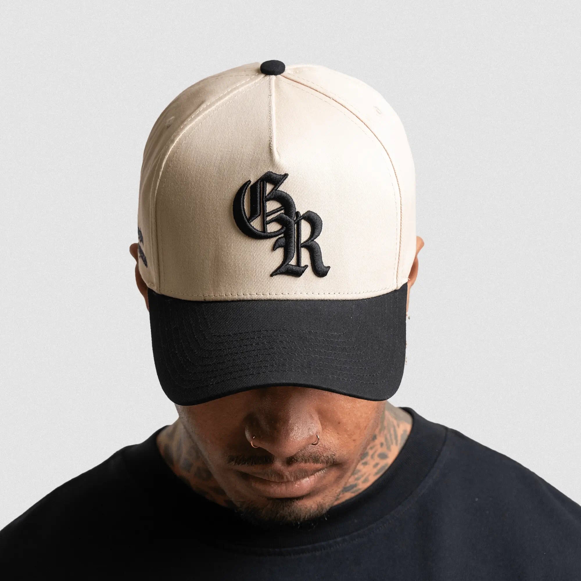 5 panel initial hat cream black on athlete studio gray background front shot