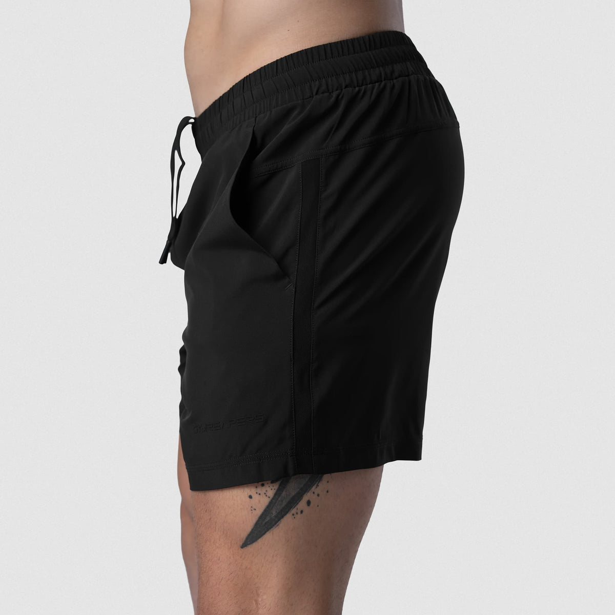 Male model wearing the Axis 6" Lined Shorts - Black/Black side profile view