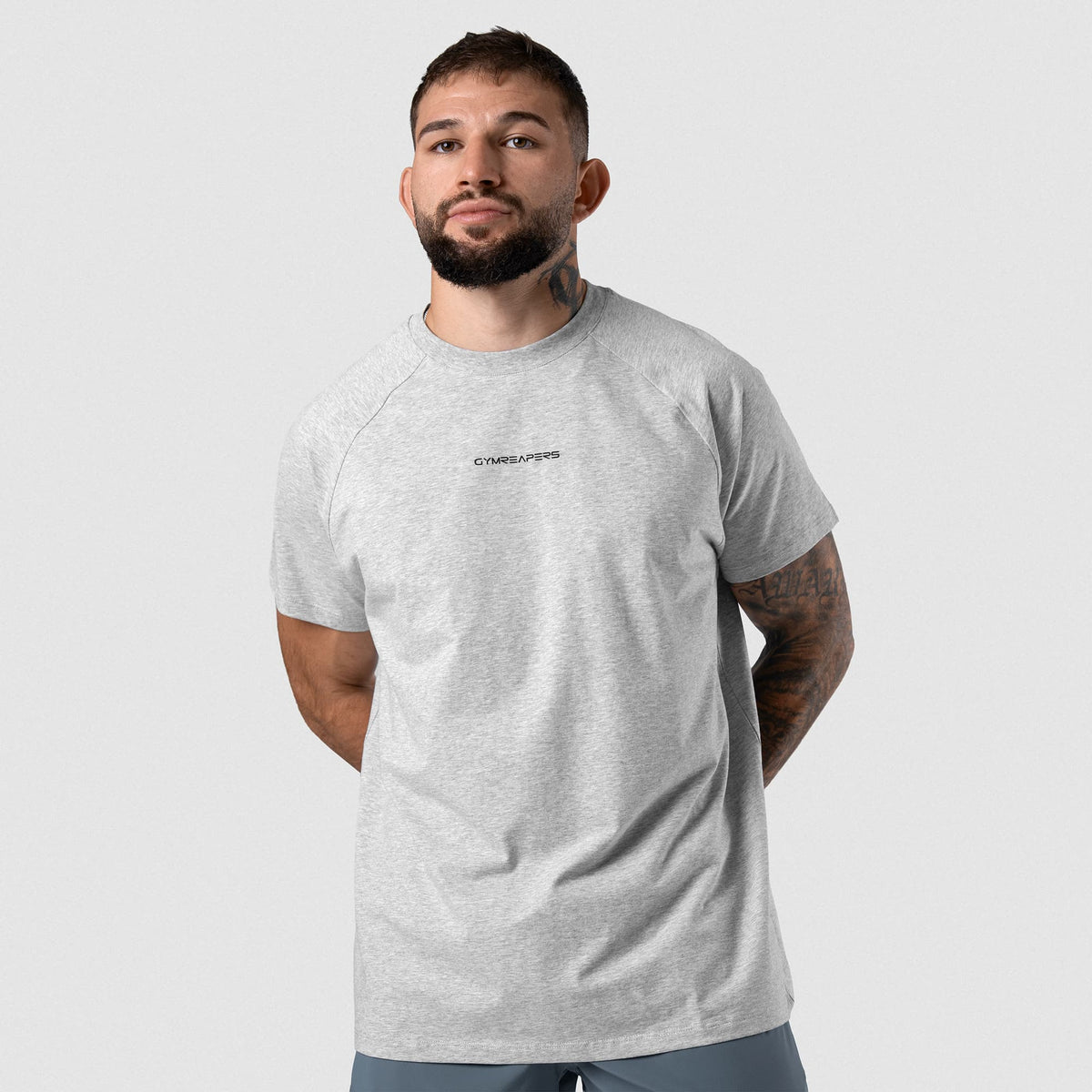 Male model wearing the Axis Raglan Tee - Heather Gray front view