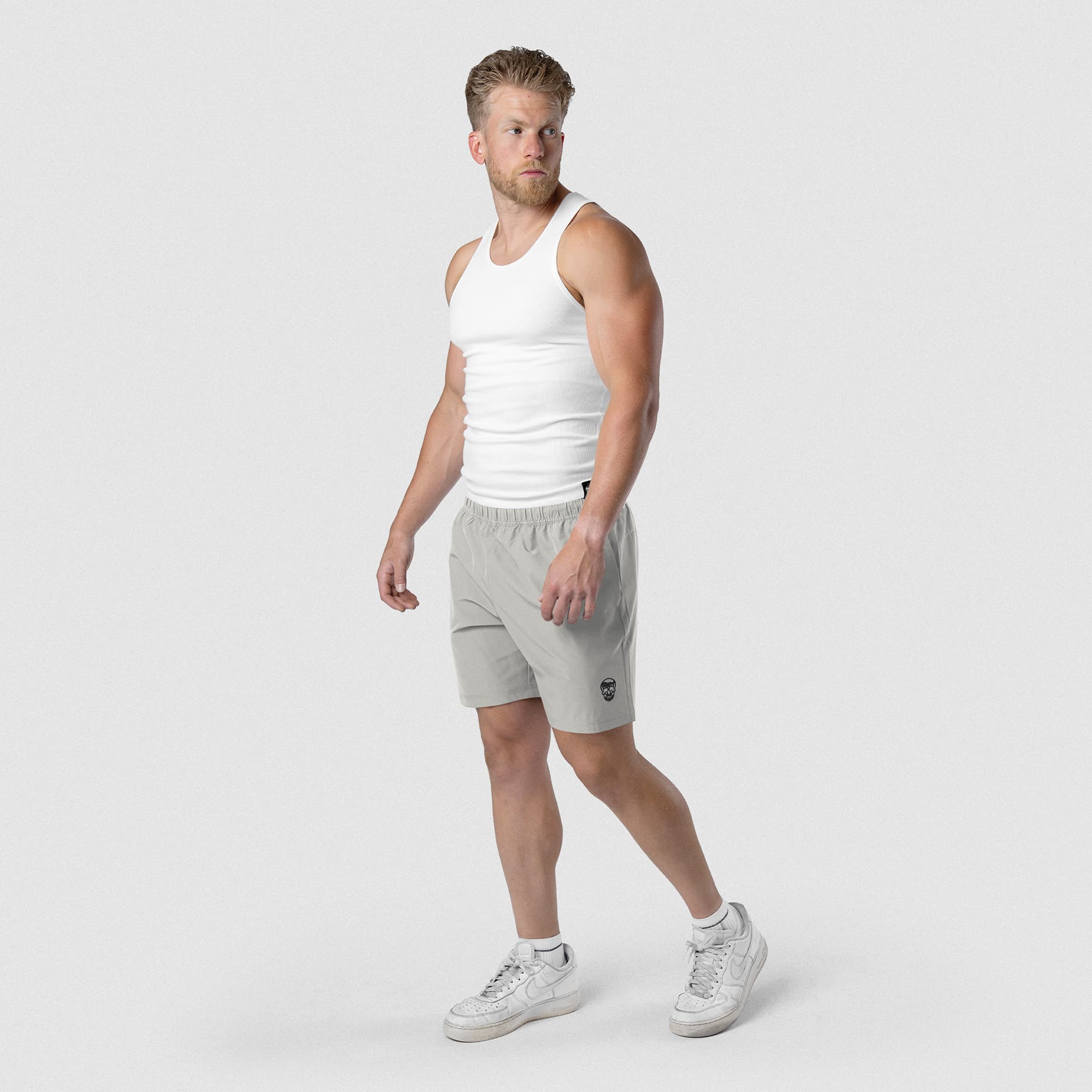 Model wearing Men's Conquer 7 Inch Shorts - Gray