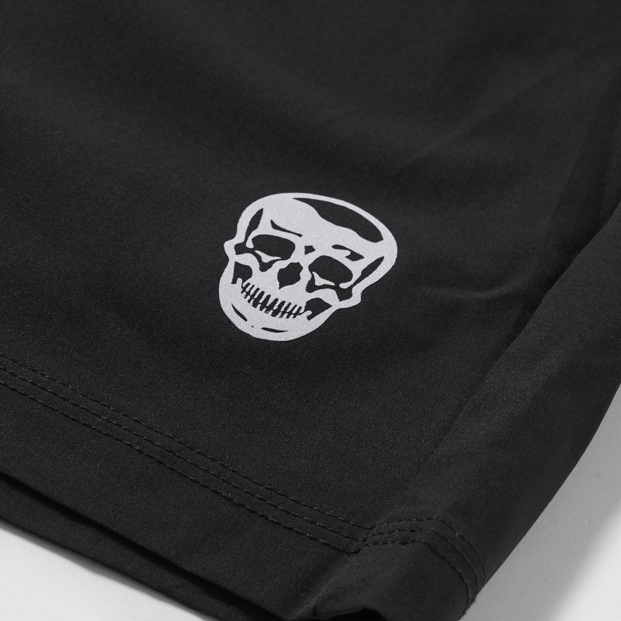 Reflective Gymreapers skull logo detail on Men's Conquer 7 Inch Shorts - Black