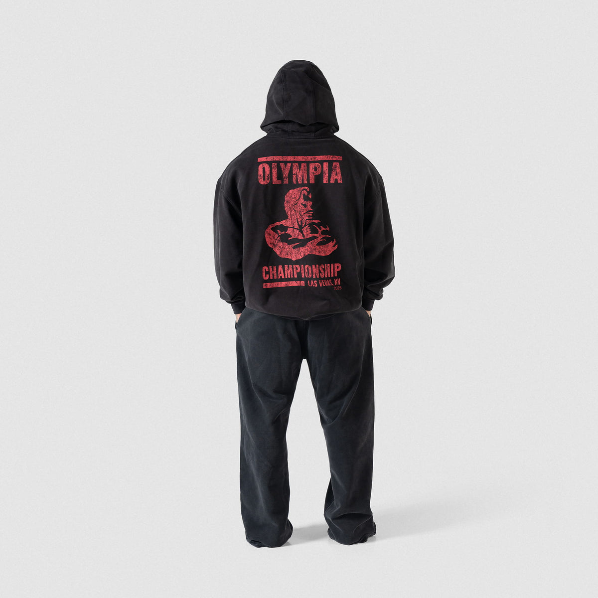 Championship Hoodie | Full body back view of male model wearing the black hoodie and matching joggers