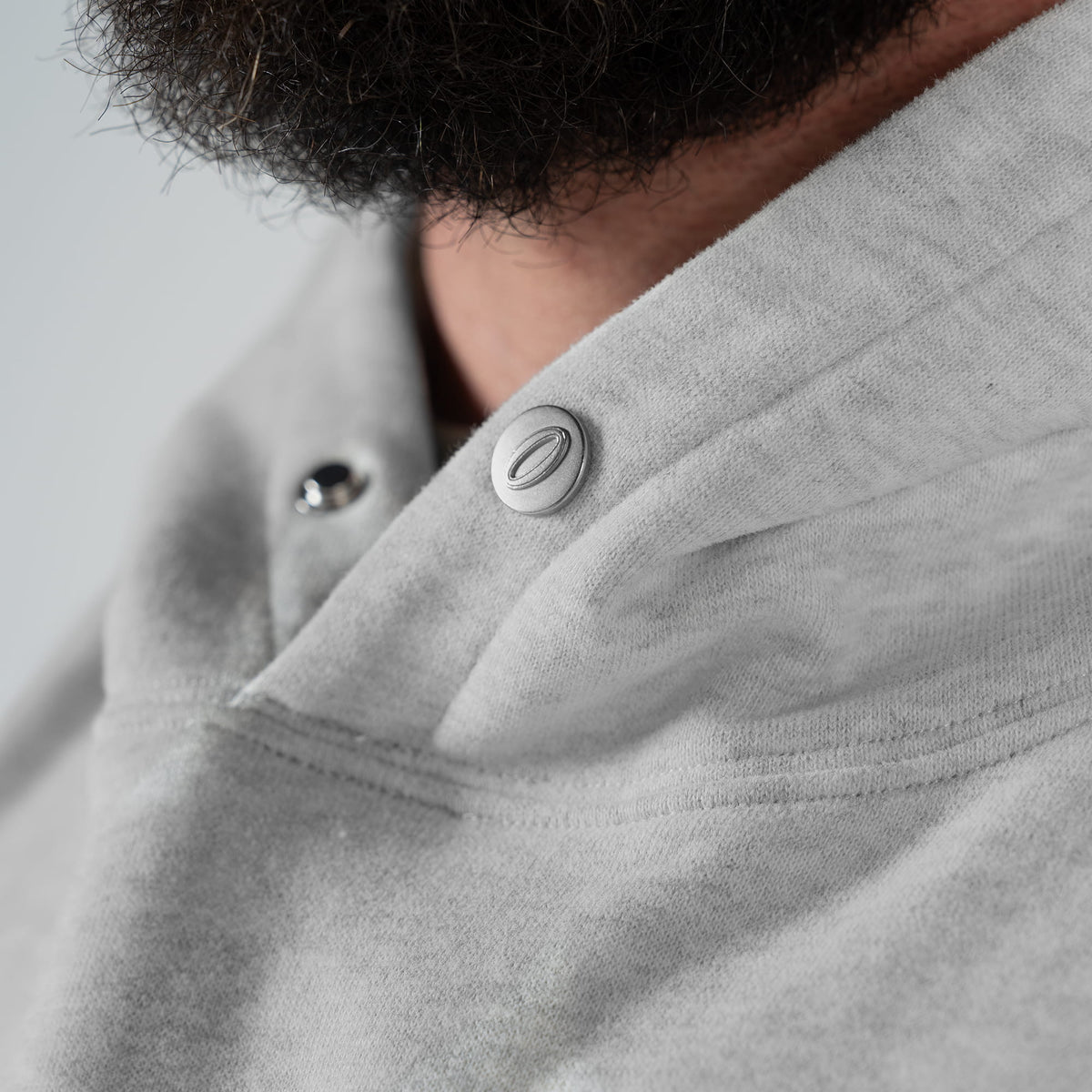 International Division Hoodie |  drawcord-free hood with silver snap-button closure feature