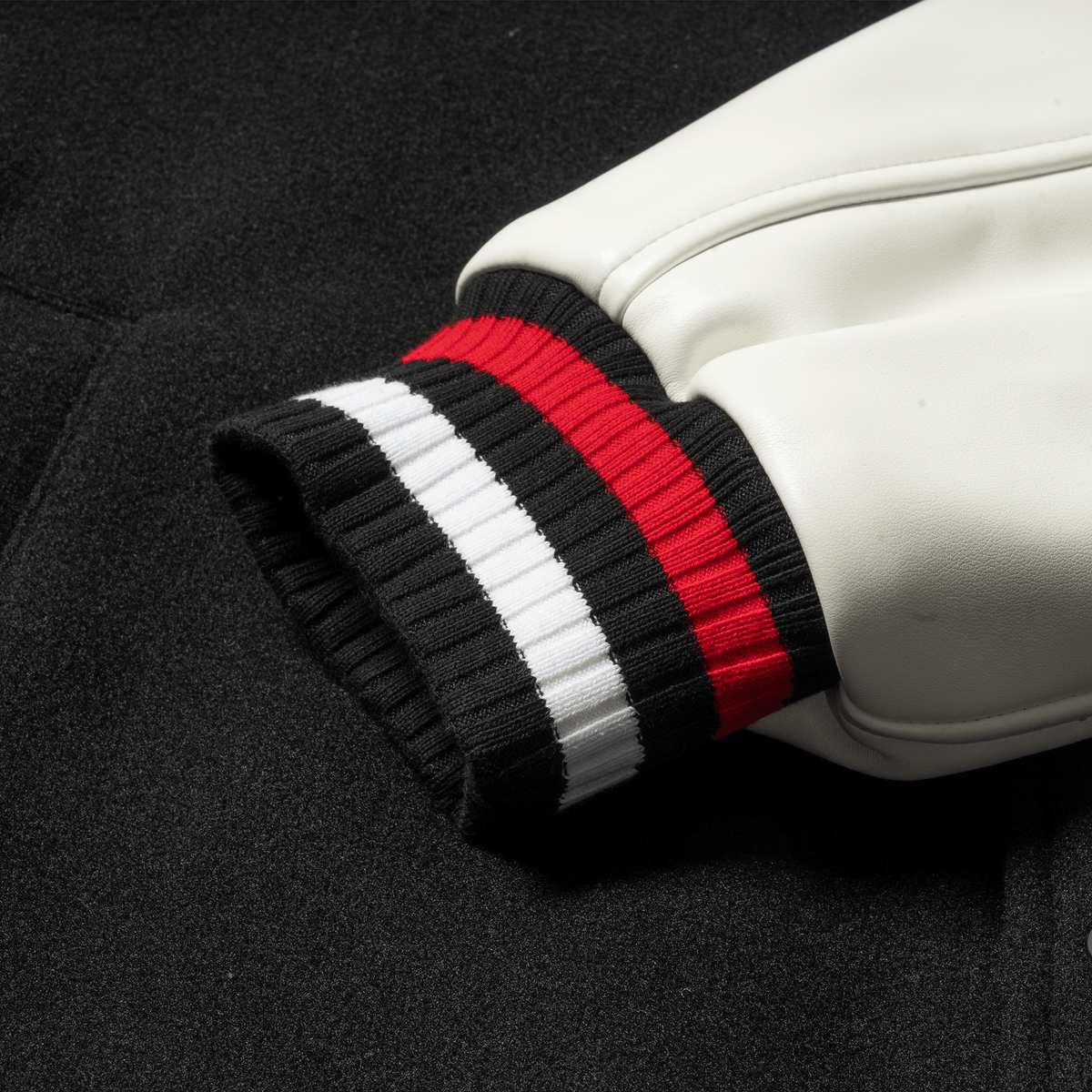 Olympia International Division Varsity Jacket in Black – Sleeve Cuff and Striped Trim Detail