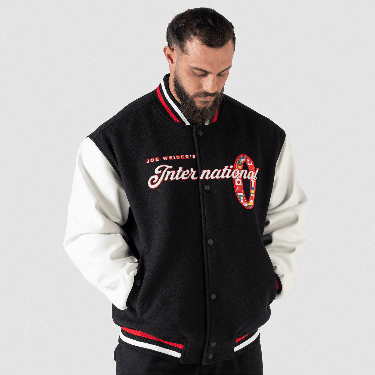 Olympia International Division Varsity Jacket in Black – On Model, Front View