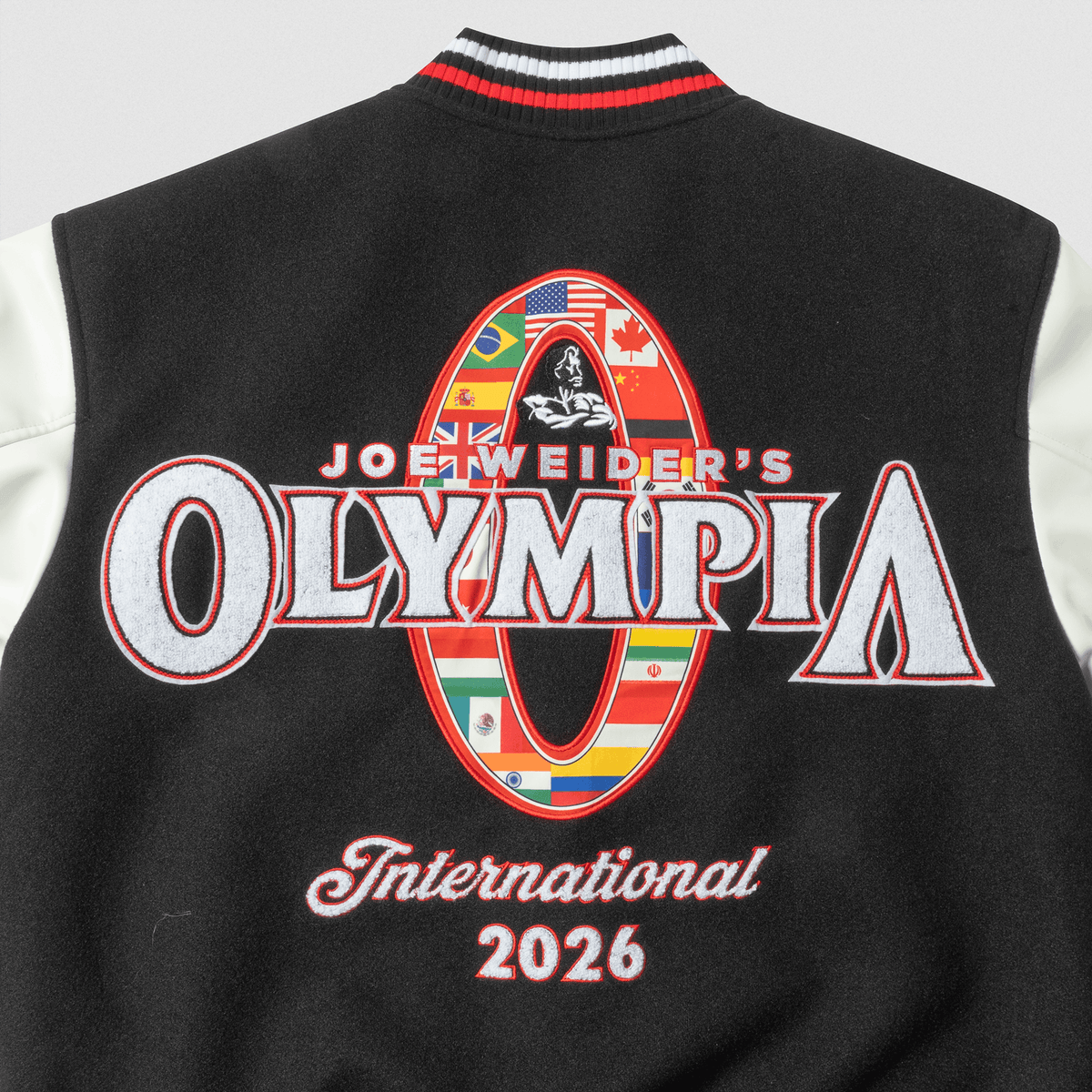 Olympia International Division Varsity Jacket in Black – Collar Patch and "Olympia International 2026" Detail