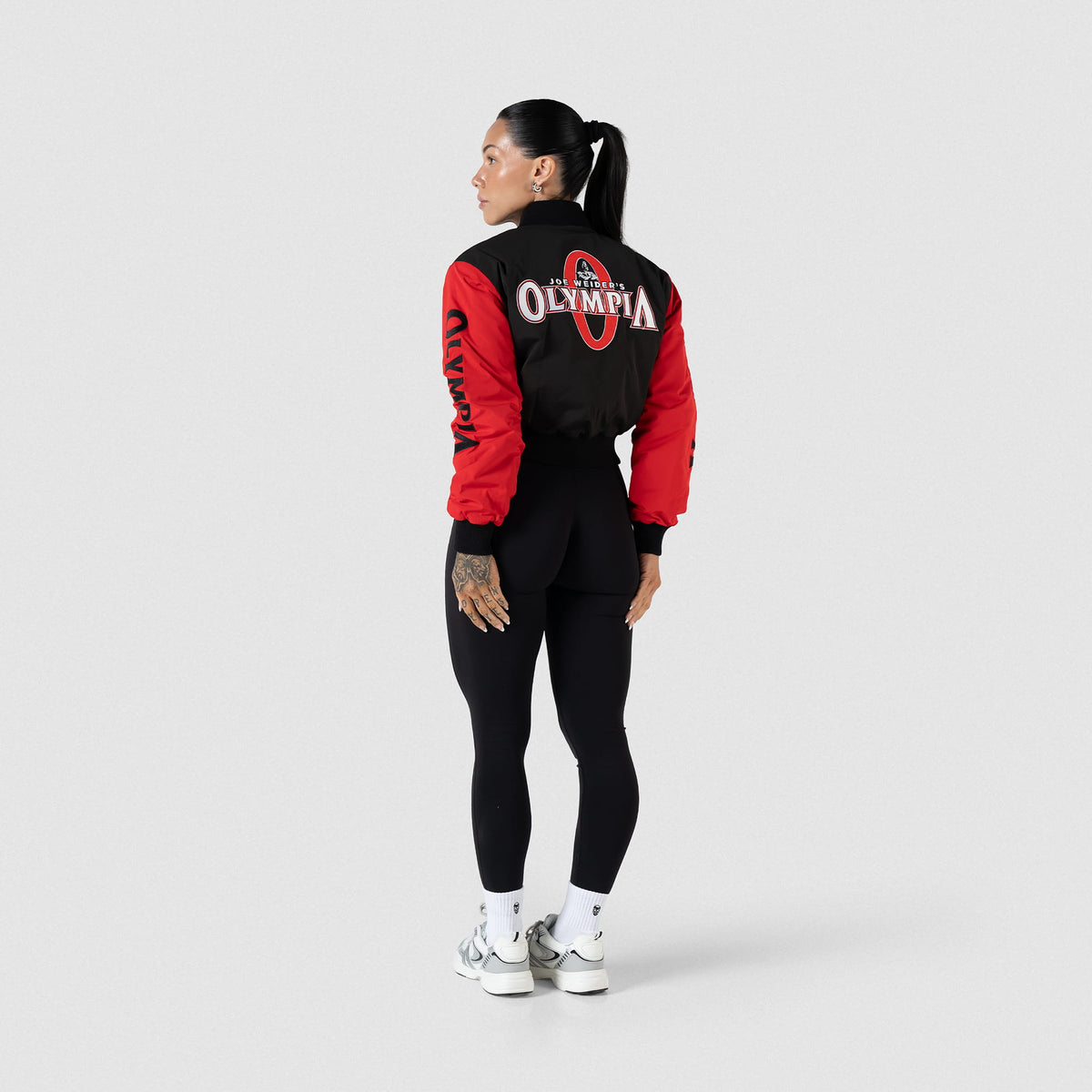 Signature Crop Bomber Jacket | Full body, back view, on model view of Bomber Jacket, paired with leggings