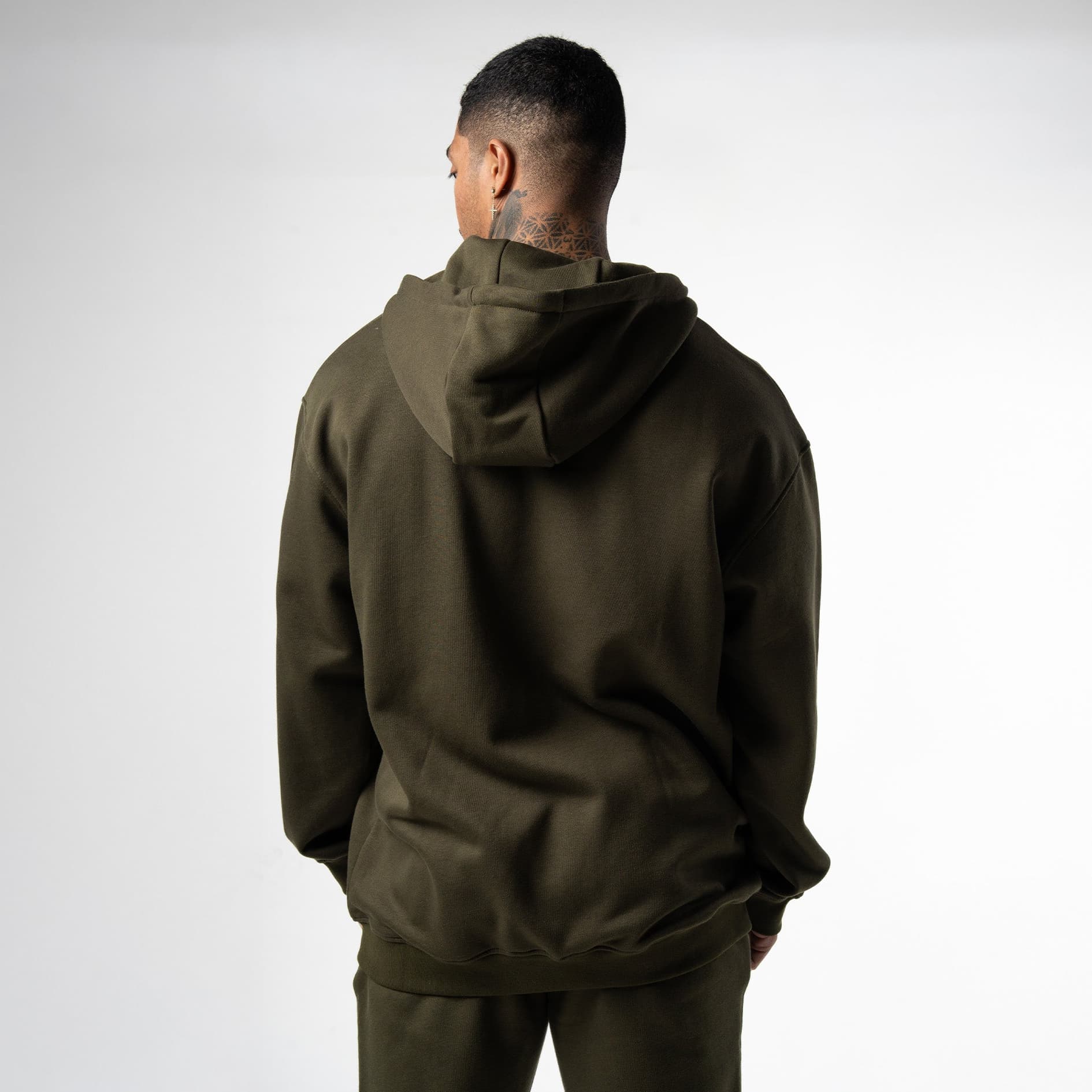 athlete wearing green axis zip up back view