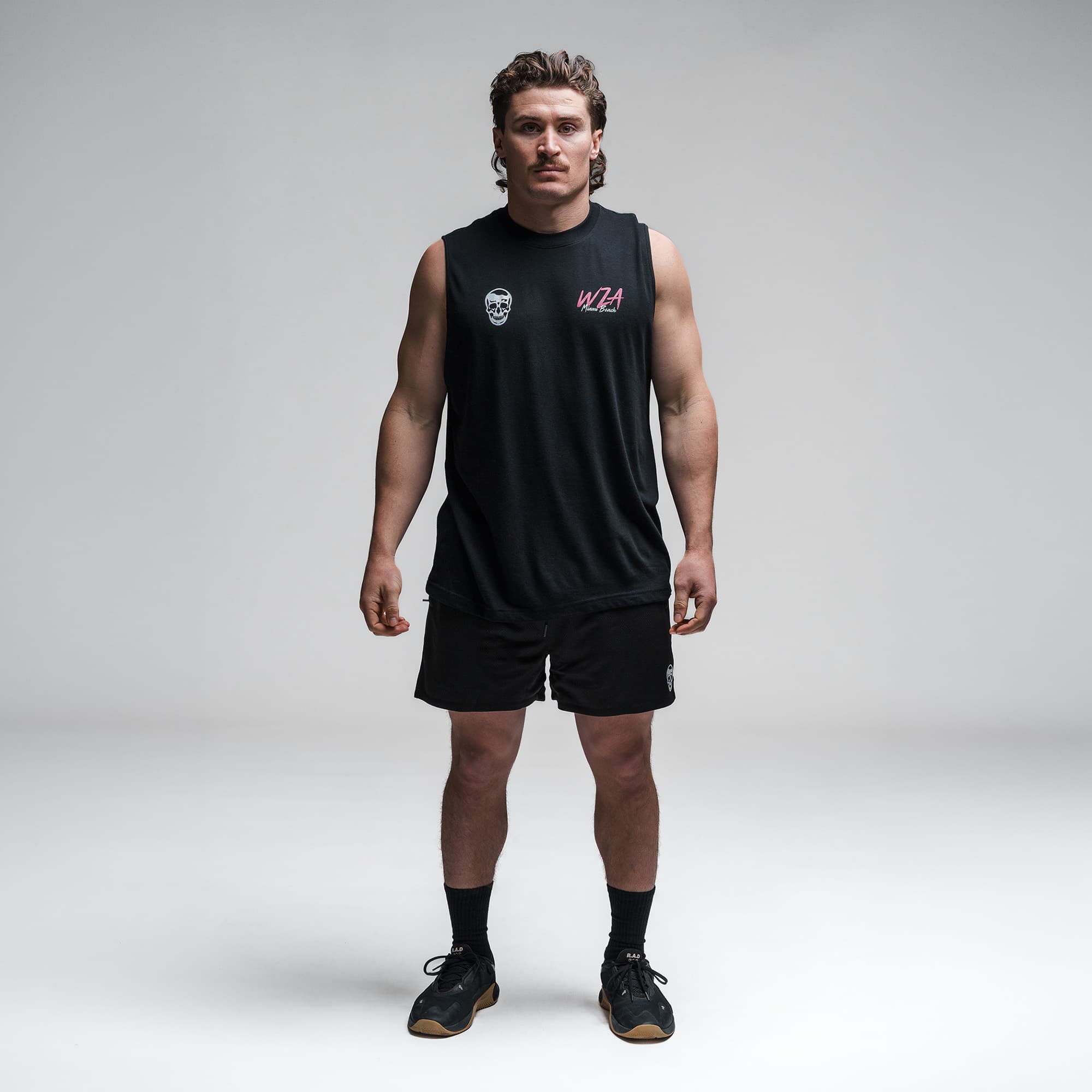 Athlete wearing the Neon Horizon Cut Off full body shot front side