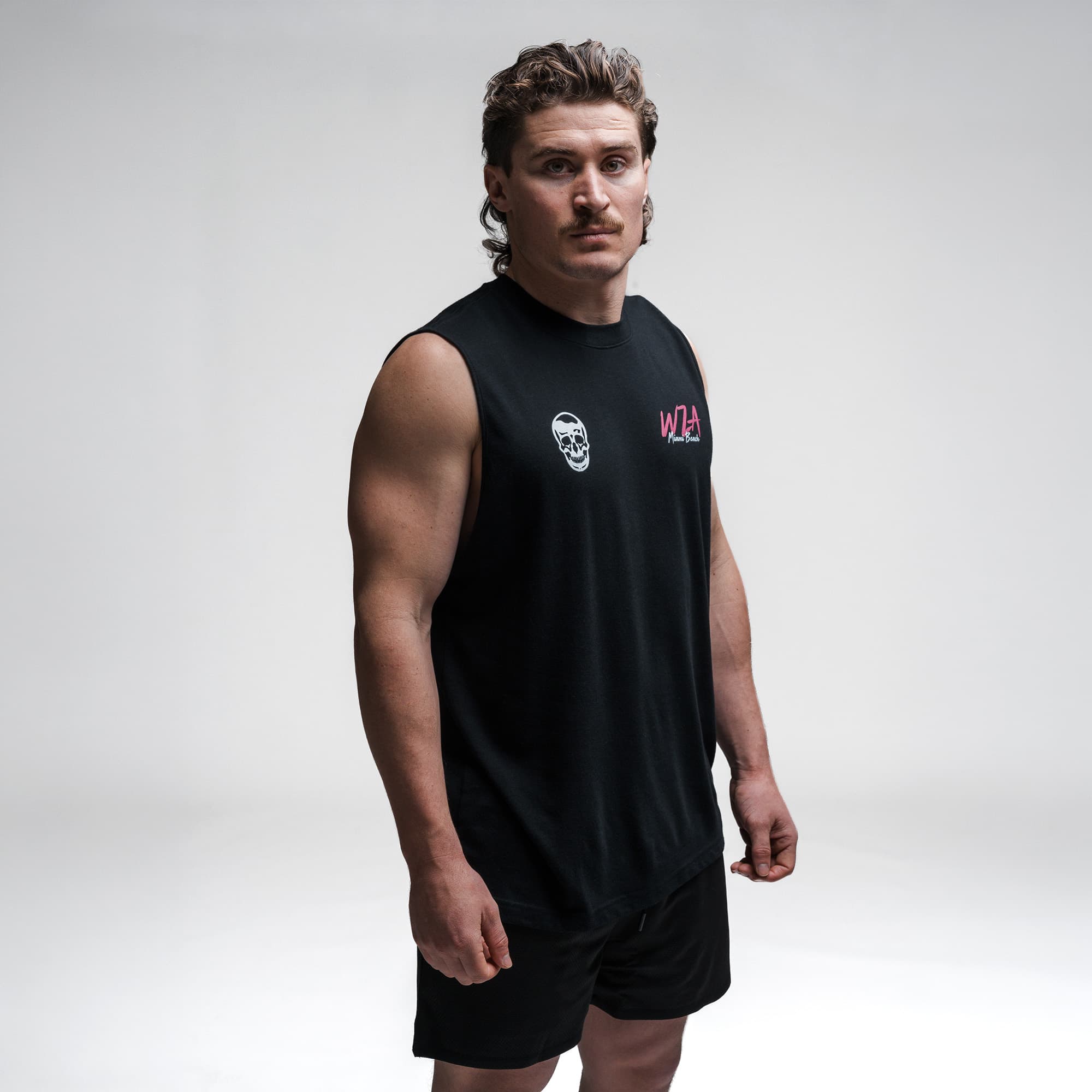 Athlete wearing the Neon Horizon Cut Off half body shot front side