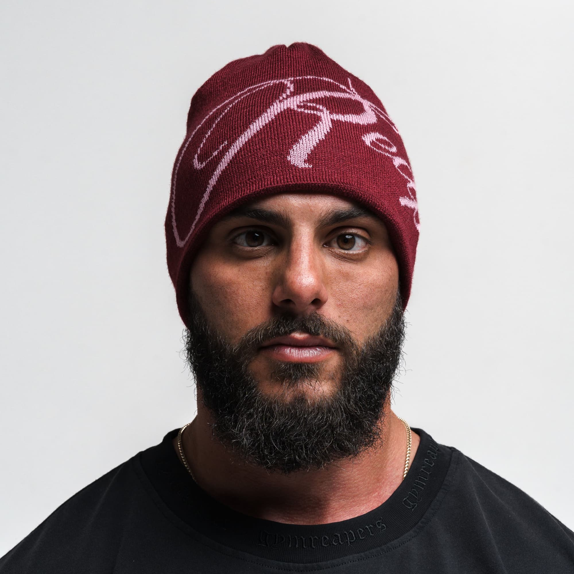 Athlete wearing Reapers Skull Cap Beanie - Maroon/Pink front view