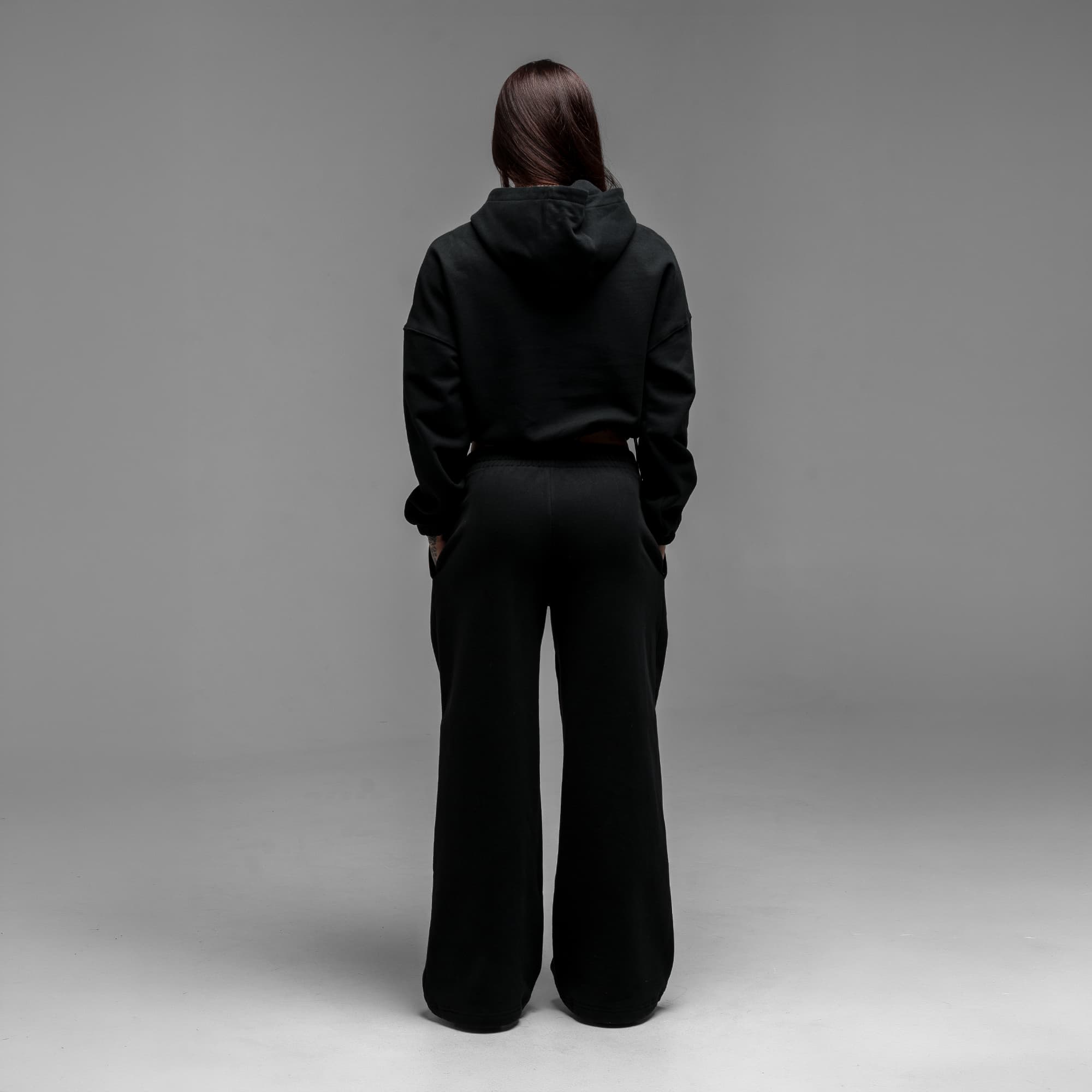 Athlete wearing Loyalty Club Cropped Hoodie full body shot back view