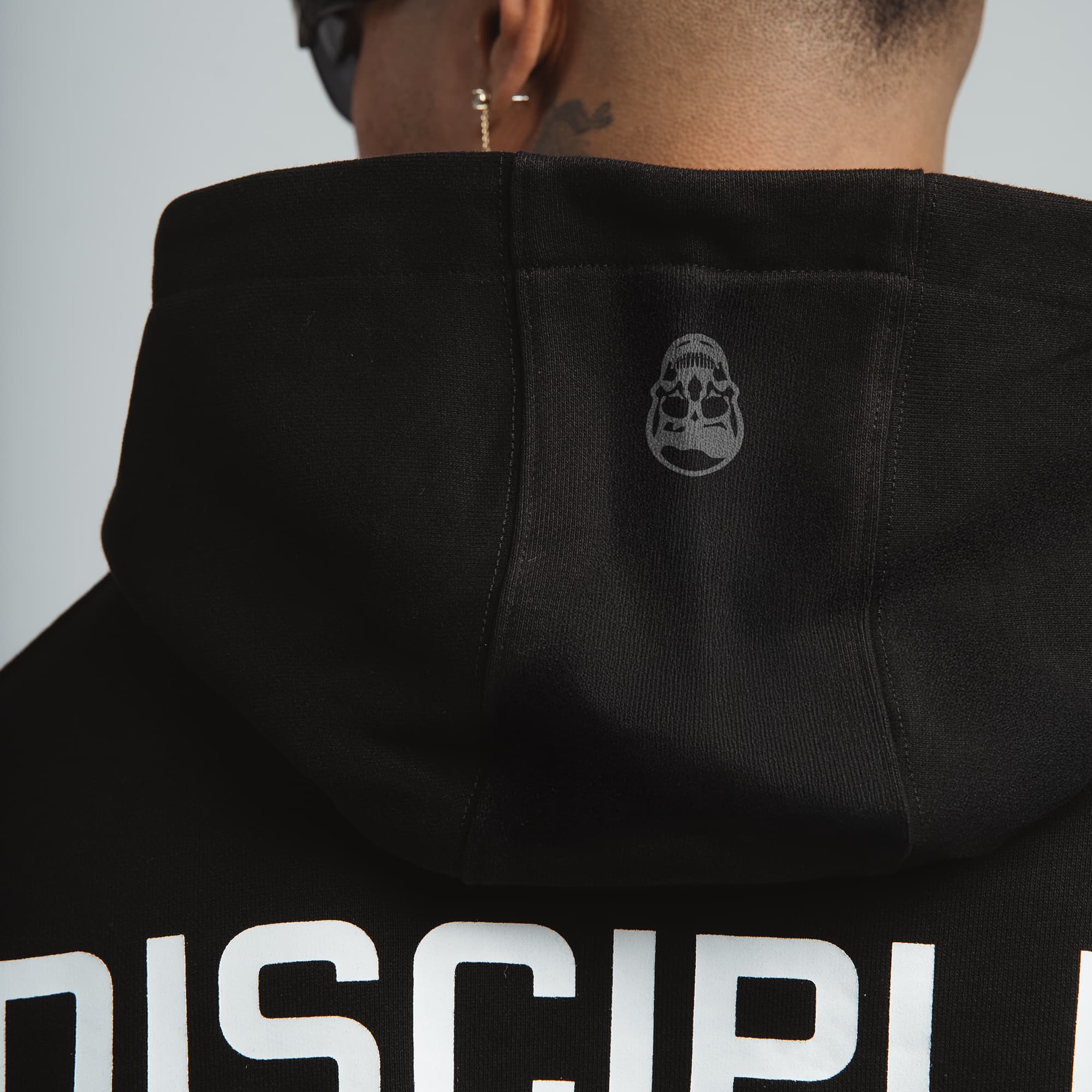 close up shot of discipline division hoodie showing skull detail
