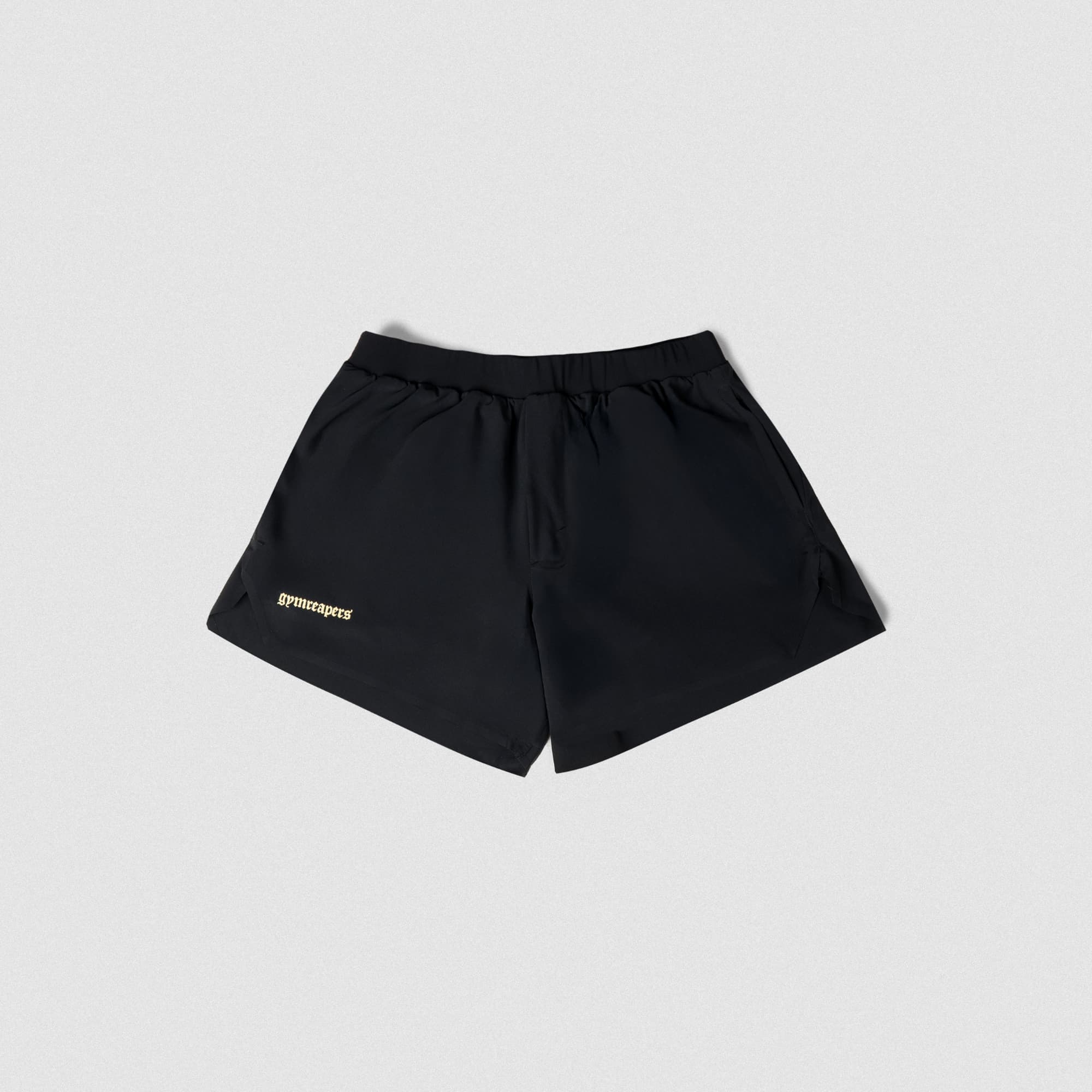 Front view of black Gymreapers running shorts with gold logo on right leg, displayed on studio gray background