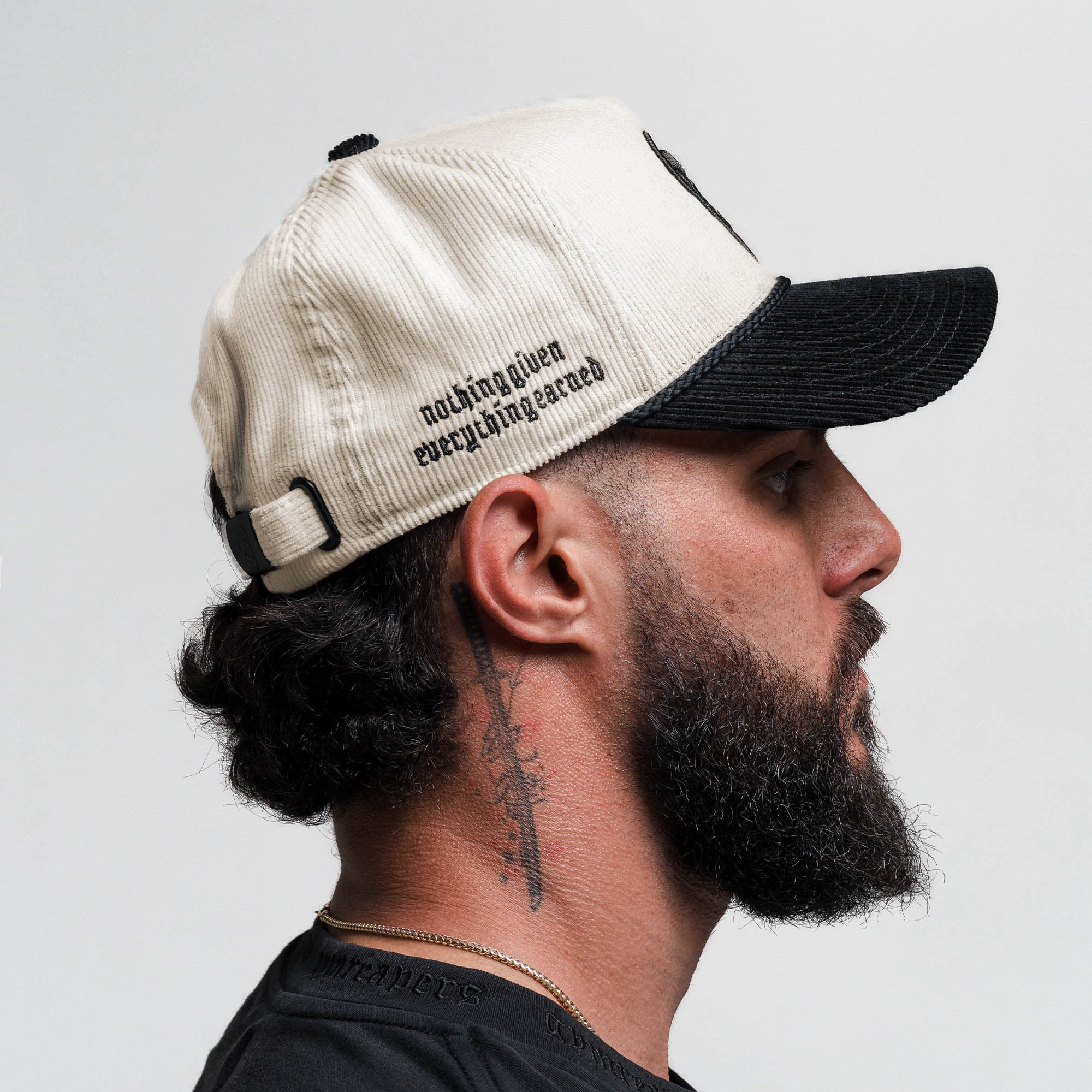 Athlete wearing Corduroy 5-Panel Skull Hat - Cream/Black side view