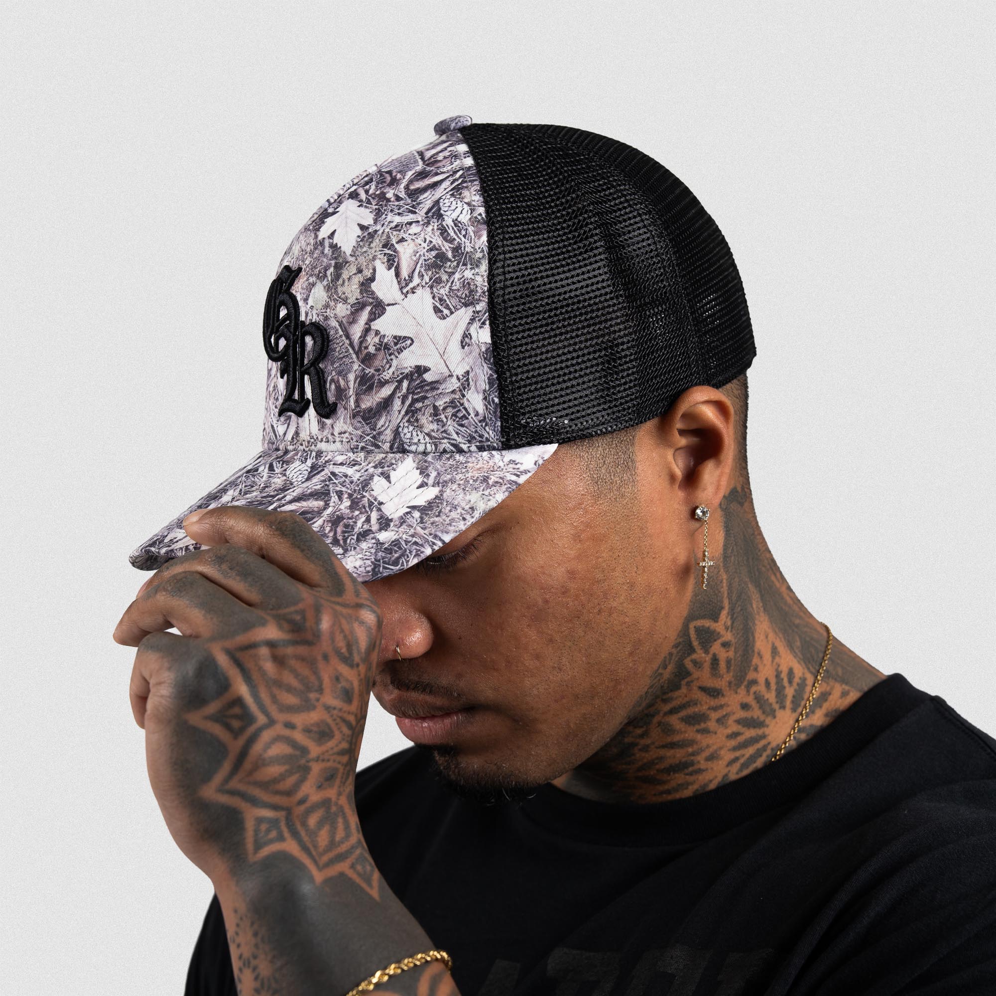 Athlete wearing Camo 5-Panel Initial Trucker Hat left side view