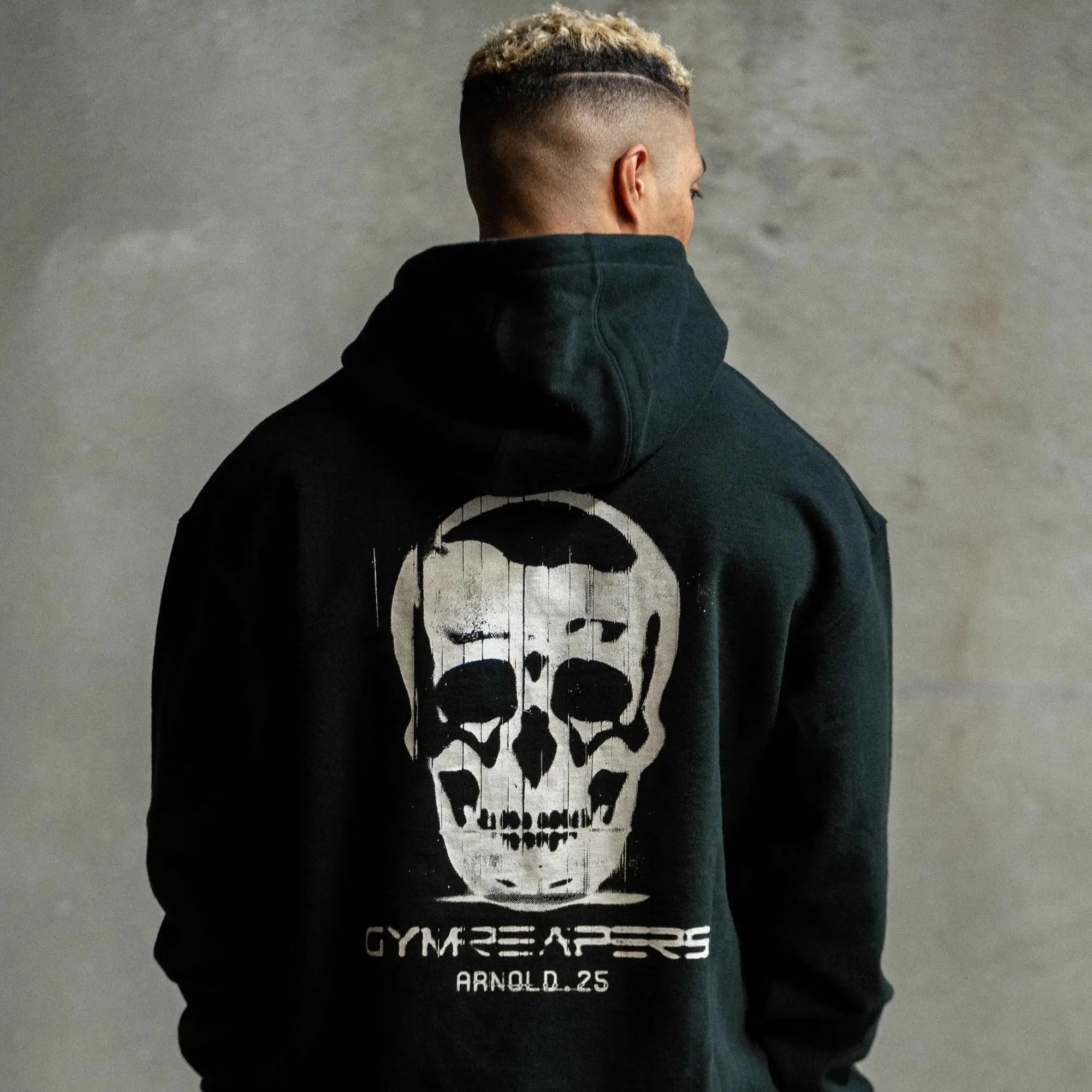 arnold 2025 hoodie back close up concrete lifestyle