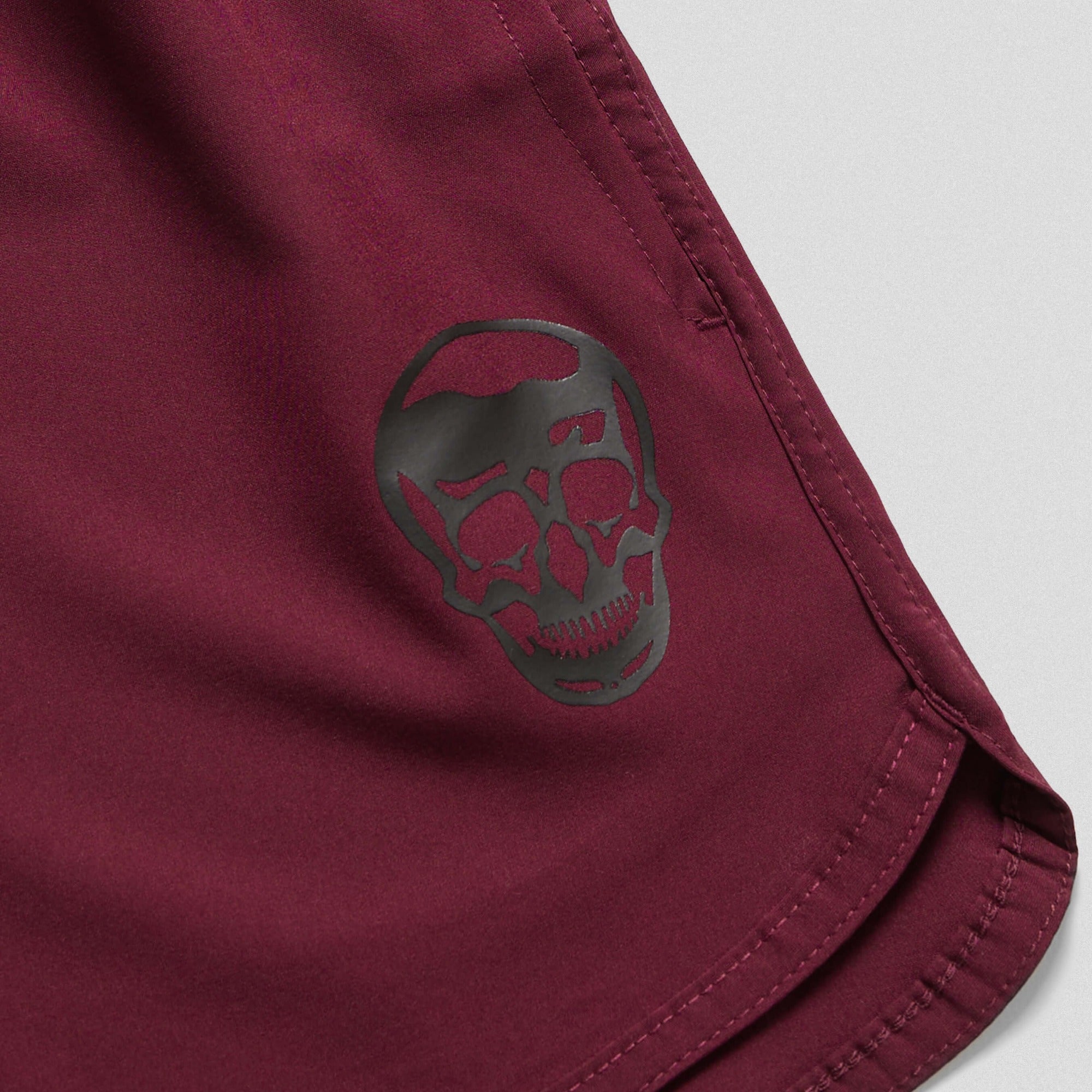 burgundy training shorts close up flat